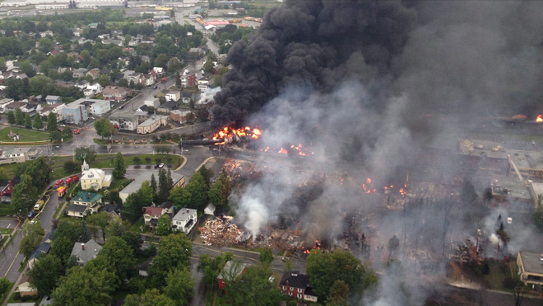 July 6, 2013: This aerial photo shows a fire in the town of Lac-Megantic as seen from a Sûreté du Québec helicopter following a train derailment that sparked several explosions in Lac Megantic, Quebec.
