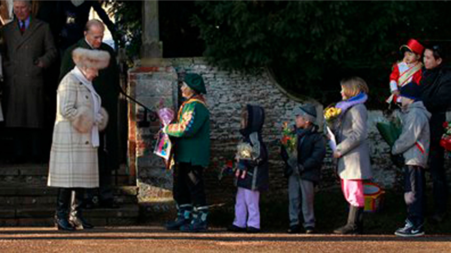 Dec. 25, 2010: Britain's Queen Elizabeth II receives flowers from children as she leaves after attending the British royal family's traditional Christmas Day church service in Sandringham, England.