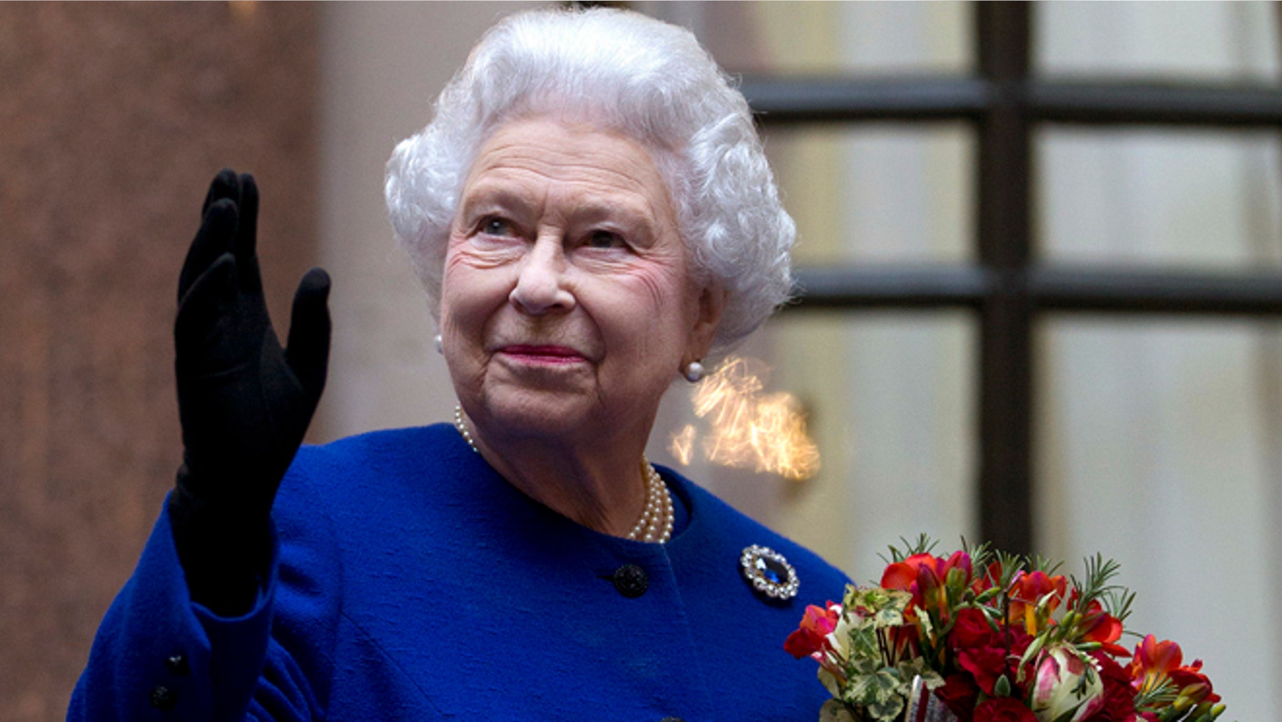 Dec. 18, 2012: In this file photo, Britain's Queen Elizabeth II looks up and waves to members of staff of The Foreign and Commonwealth Office as she ends an official visit which is part of her Jubilee celebrations in London. She has no formal political role, but Queen Elizabeth II has been named Britain's most powerful woman by a BBC radio program.
