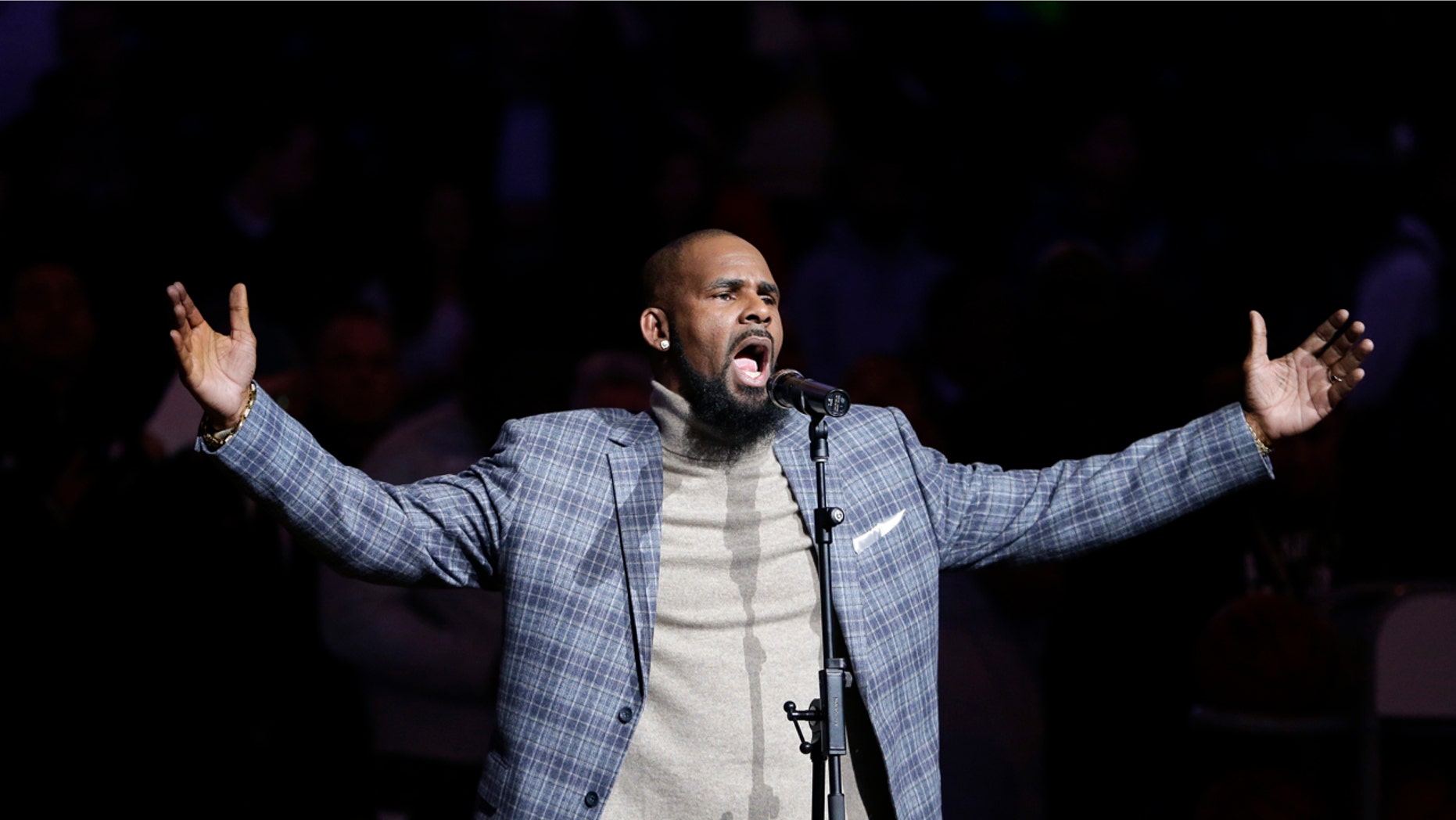 FILE - In this Nov. 17, 2015 file photo, R. Kelly performs the national anthem before an NBA basketball game between the Brooklyn Nets and the Atlanta Hawks in New York. Court documents show the R&B singer has been evicted from two Atlanta-area homes over unpaid rent. The Feb. 13, 2018 filings with the Fulton County magistrate court show Kelly owes more than $31,000 in past due payments to SB Property Management Global. (AP Photo/Frank Franklin II, File)