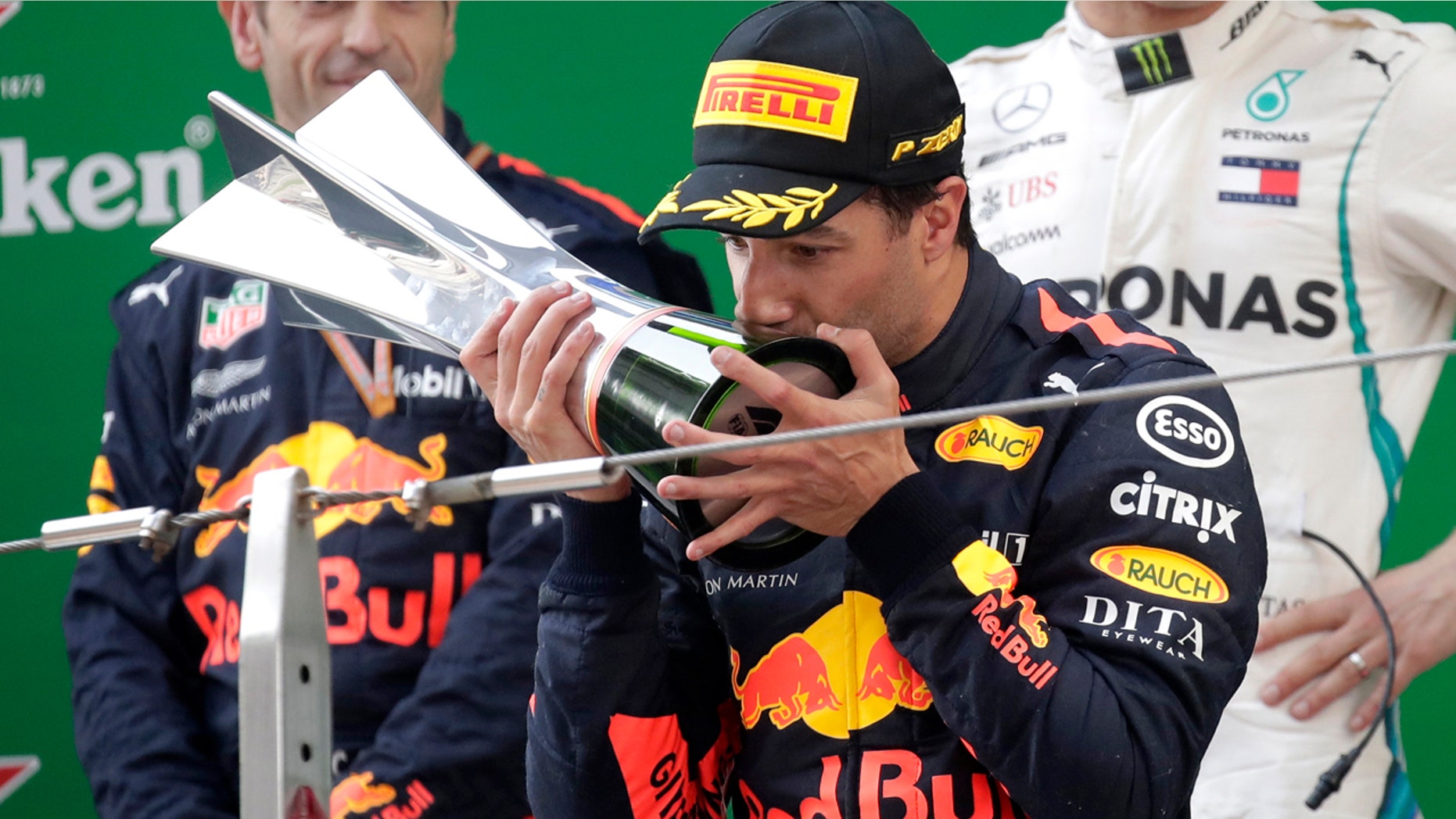 Red Bull driver Daniel Ricciardo of Australia kisses his trophy as he celebrates after winning the Chinese Formula One Grand Prix at the Shanghai International Circuit in Shanghai, Sunday, April 15, 2018.