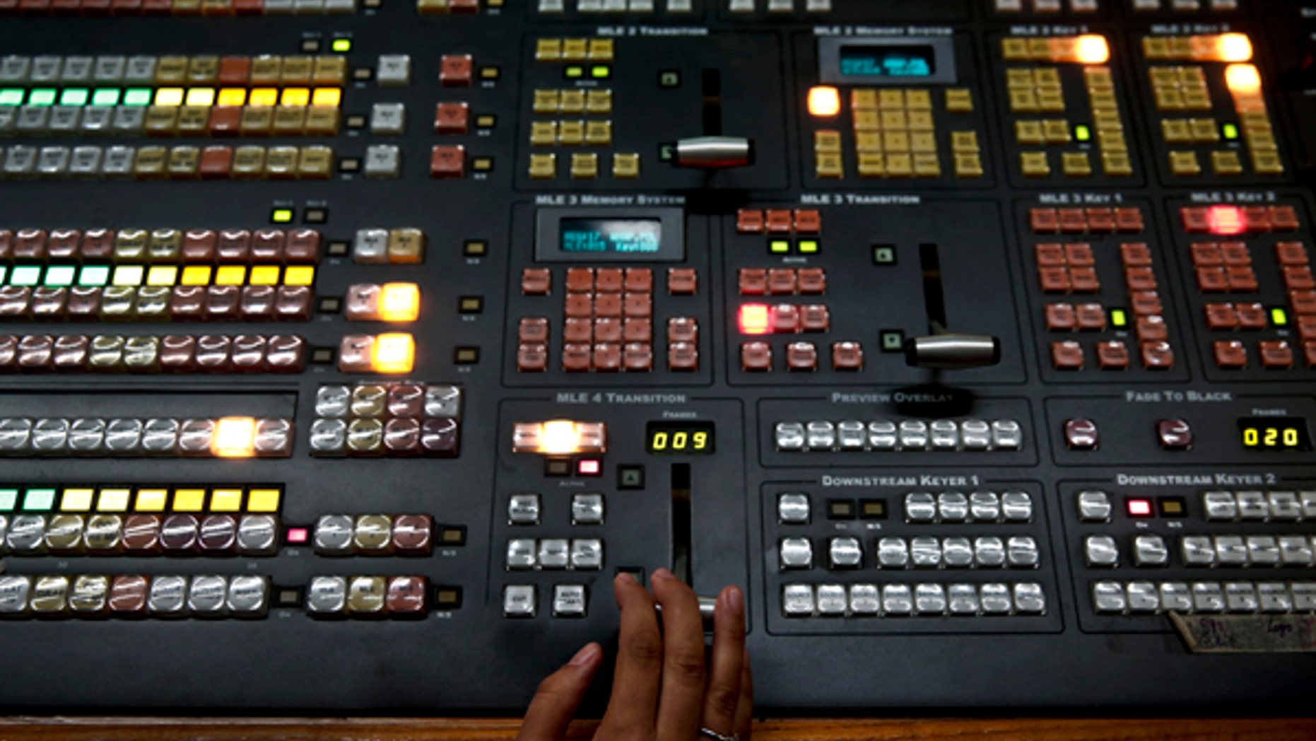 An employee operates a mixing console at the control room of state broadcaster ERT headquarters in Athens June 17, 2013. Greek Prime Minister Antonis Samaras faced a double challenge on Monday from coalition partners furious over the shutdown of state broadcaster ERT and a court hearing that could put the shuttered station back on air. REUTERS/Yorgos Karahalis (GREECE - Tags: BUSINESS POLITICS MEDIA EMPLOYMENT) - RTX10QP0