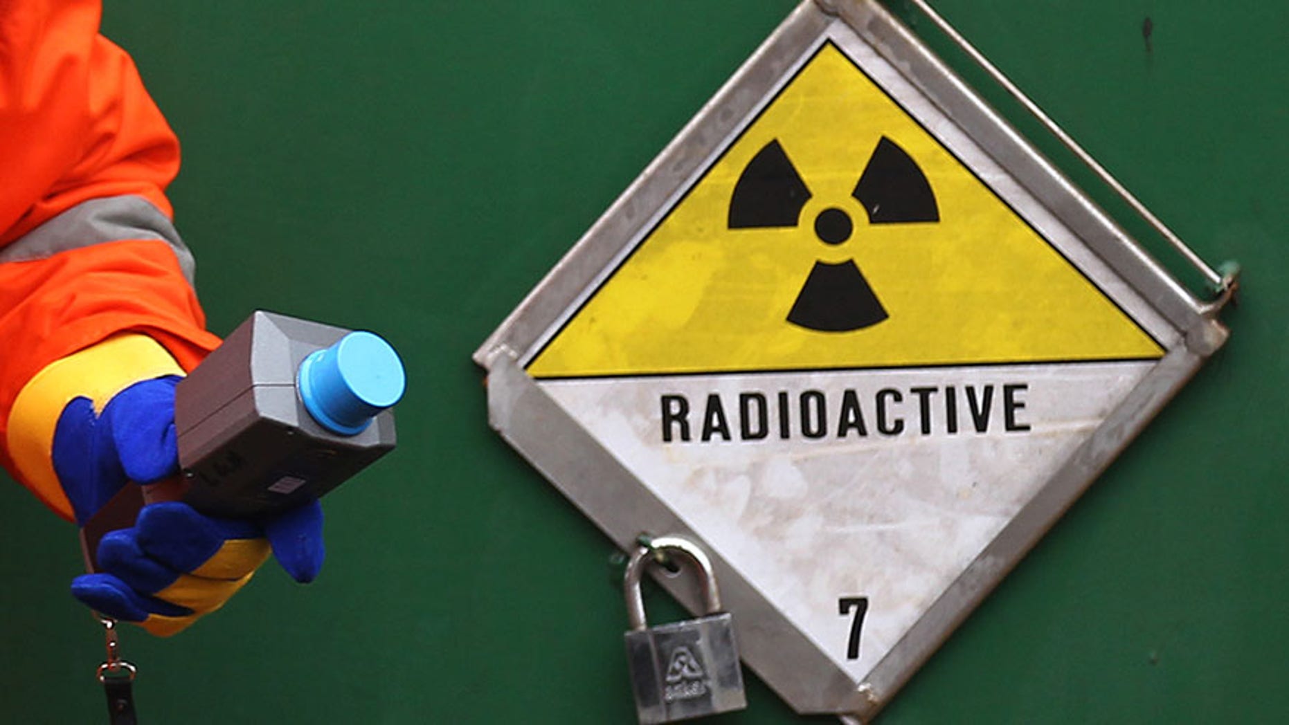 A German police officer uses a Geiger counter to measure the radiation of a Castor container on a transport train, during a stop in Neunkirchen near Saarbruecken November 25, 2011. The Castor (Cask for Storage and Transport Of Radioactive material) train is carrying 11 containers of spent German nuclear fuel on route from France after being reprocessed, to the nuclear waste storage facility of Gorleben in north eastern Germany. REUTERS/Alex Domanski (GERMANY - Tags: POLITICS ENVIRONMENT) - RTR2UGDT