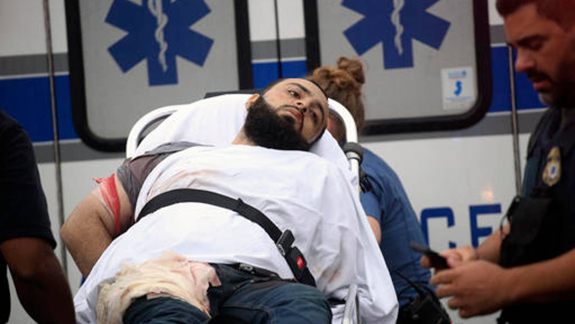 Ahmad Khan Rahami is taken into custody after a shootout with police Monday, Sept. 19, 2016, in Linden, N.J. Rahami was wanted for questioning in the bombings that rocked the Chelsea neighborhood of New York and the New Jersey shore town of Seaside Park. (Nicolaus Czarnecki/Boston Herald via AP)
