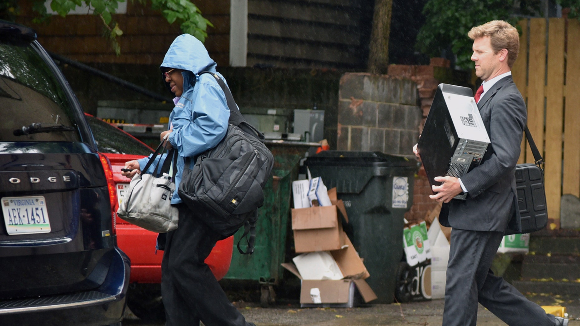 Federal Agents exit the back of an office building as the FBI serves a search warrant at the office of Strategic Campaign Group on Thursday, May 11, 2017 in Annapolis, Md.