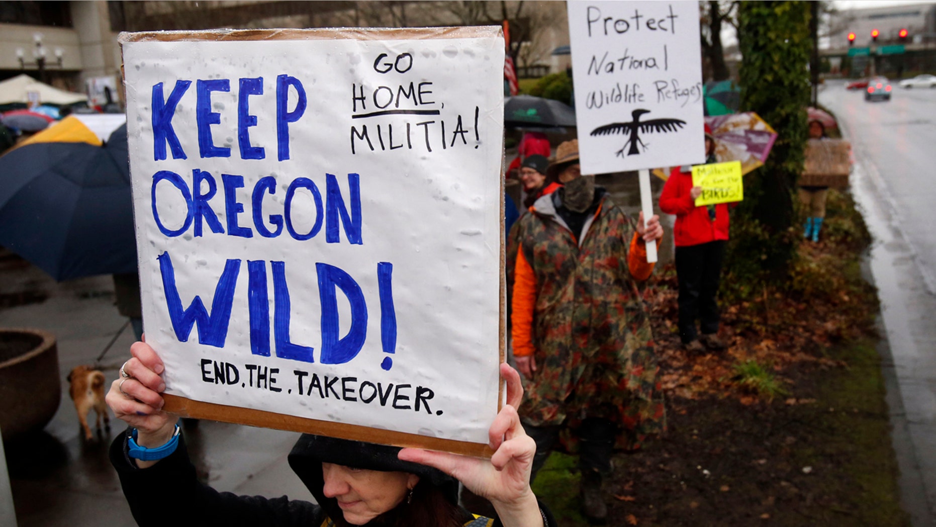 Jan. 19, 2016: Renee Irvin holds a sign during a rally against the occupation of the Malheur National Wildlife Refuge by Ammon Bundy and his armed followers, while joining the rally at the Federal Building in Eugene, Ore. (Andy Nelson/The Register-Guard via AP)