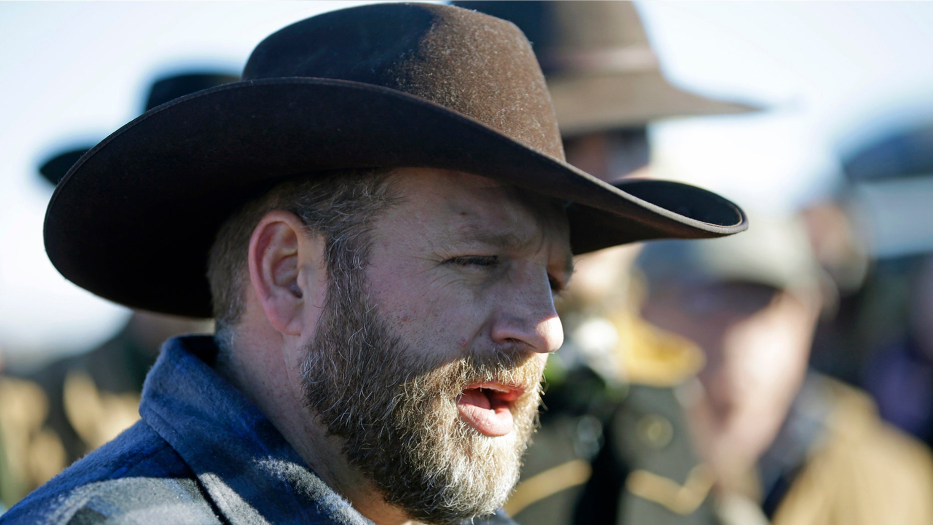 Ammon Bundy speaks with reporter at a news conference at Malheur National Wildlife Refuge Friday, Jan. 8, 2016, near Burns, Ore. Bundy, the leader of an armed group occupying the national wildlife refuge to protest federal land management policies, said Friday he and his followers are not ready to leave even though the sheriff and many locals say the group has overstayed their welcome. (AP Photo/Rick Bowmer)