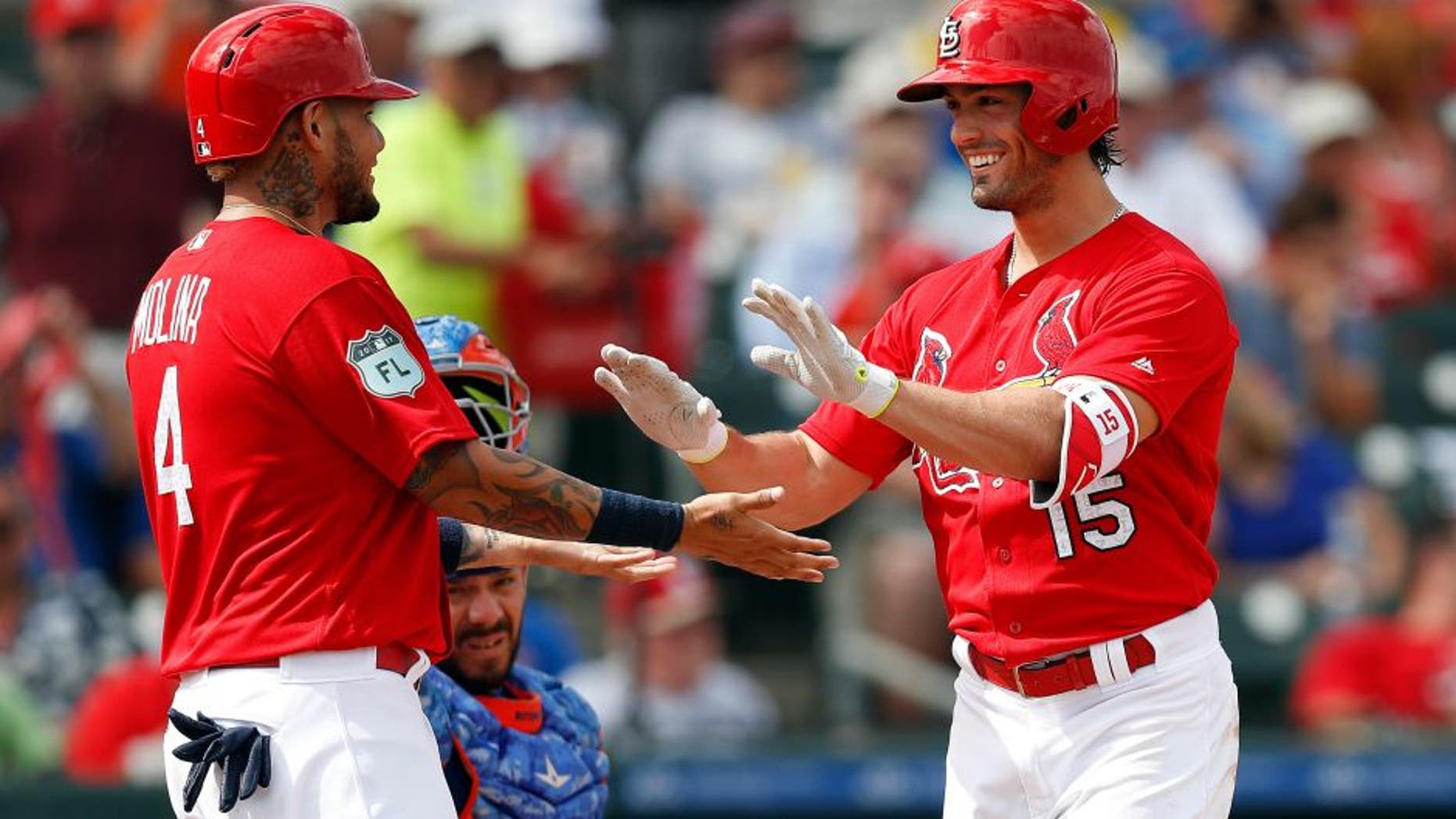 St. Louis Cardinals' Randal Grichuk (15) celebrates with Yadier Molina (4), left, after hitting a three-run home run in the third inning of a spring training baseball game against the New York Mets, Wednesday, March 1, 2017, in Jupiter, Fla. (AP Photo/John Bazemore)