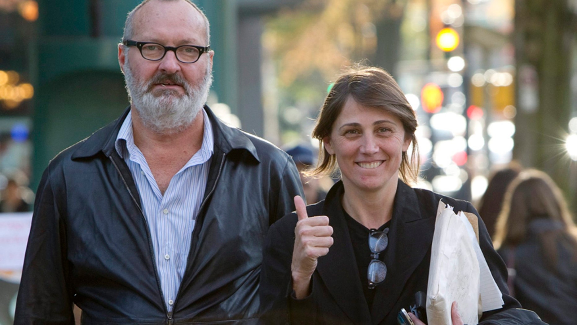 FILE - This Oct. 27, 2010 file photo shows, actor Randy Quaid, left, and his wife Evgenia outside their lawyer's office in Vancouver. Quaid and his wife sued John Kerry and the State Department on Monday, Dec. 15, 2014, to recover passports that the government revoked three years ago. The actor said the revocation involved an issue over "an insurance policy that we did not take out," but declined to discuss it further.