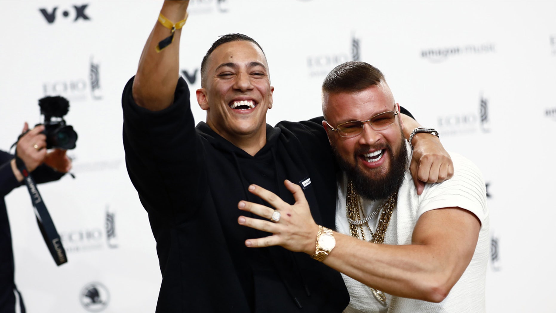 German rappers Kollegah, right, and Farid Bang pose upon arrival for the 2018 Echo Music Award ceremony.