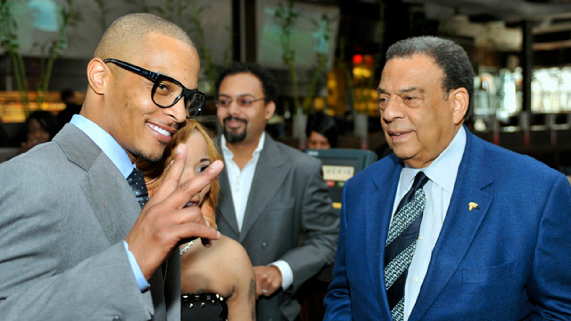 Oct. 3, 2010: Grammy award winning artist Clifford "TI" Harris, left, poses for photographers as he speaks with former Congressman and U.N. ambassador Andrew Young, right, during a recent Alzheimers benefit in Atlanta.