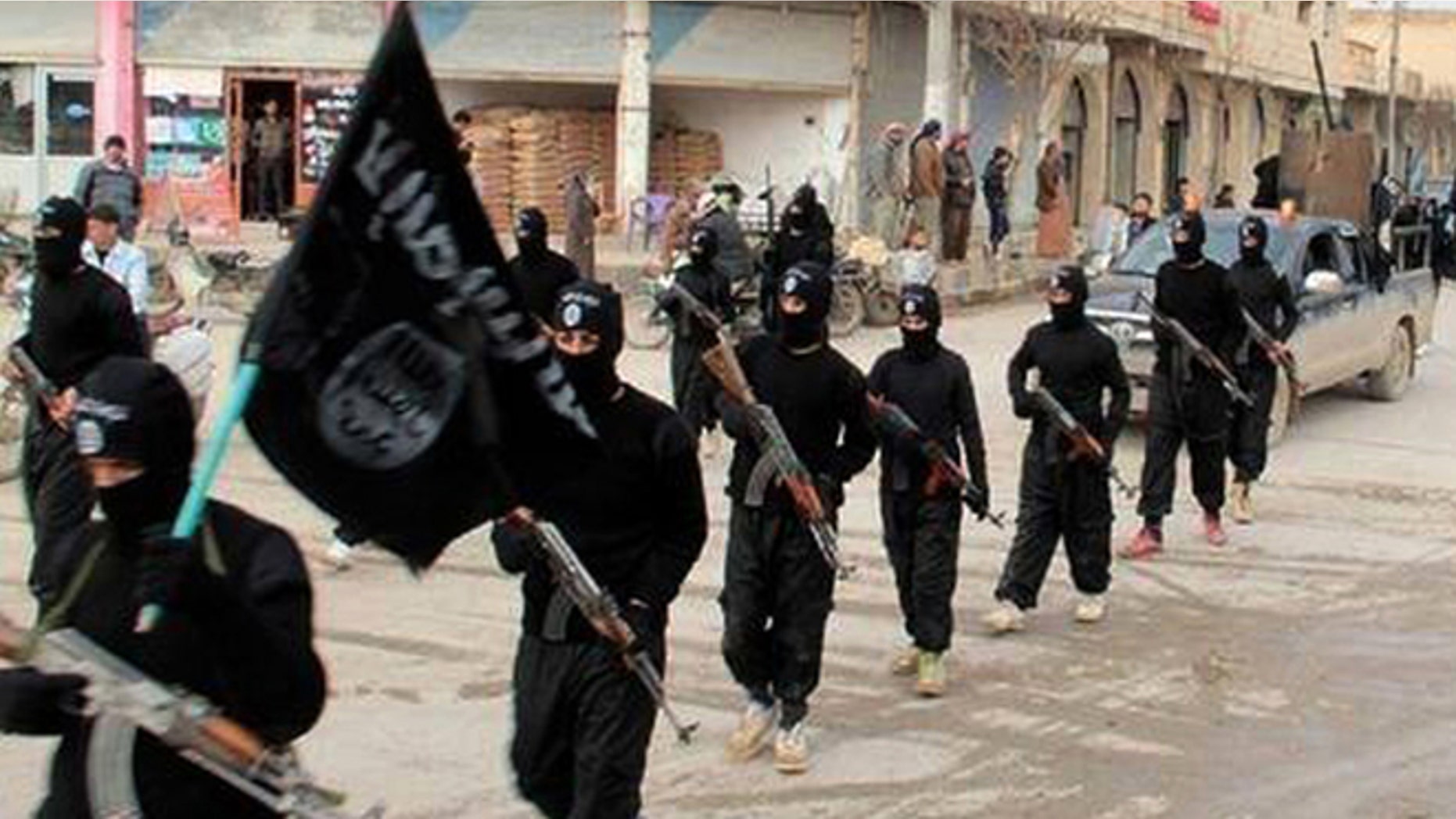 ISIS fighters march in Raqqa, Syria.