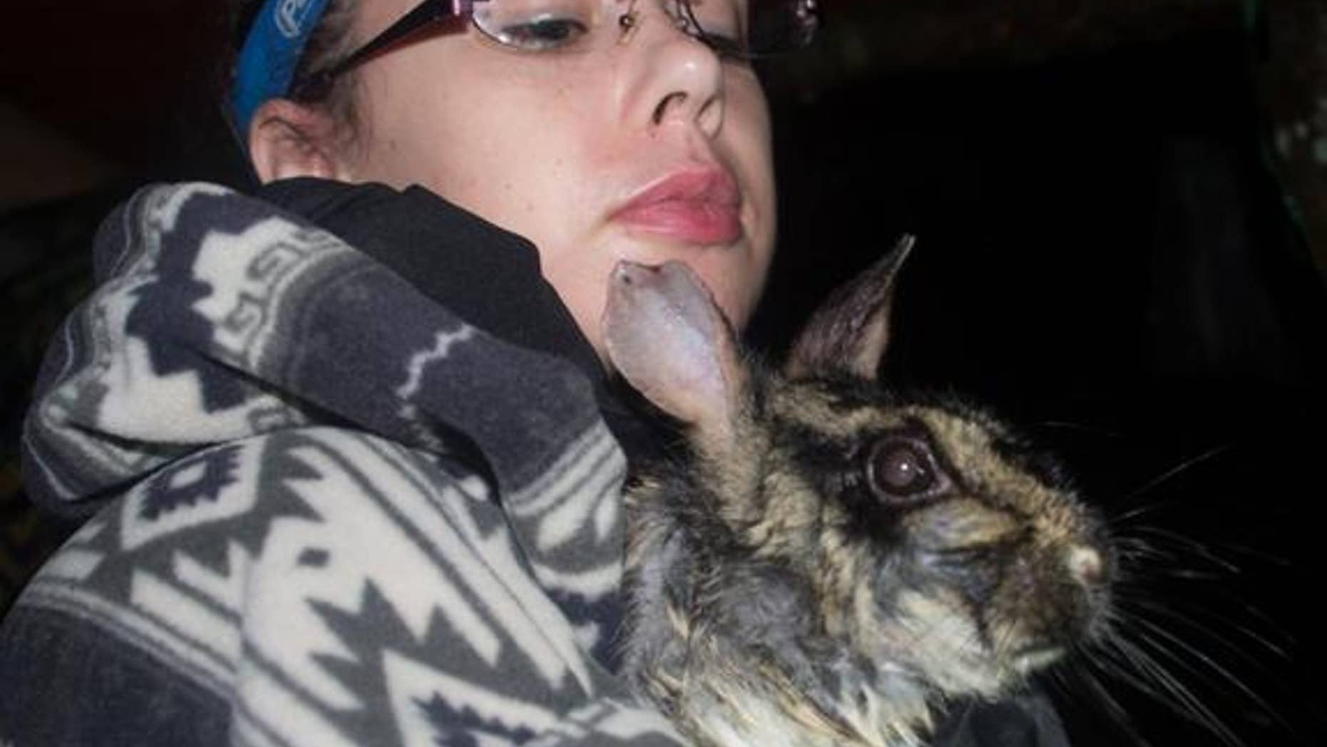A rare and elusive rabbit is held by University of East Anglia graduate student researcher Sarah Woodfin in Vietnam.