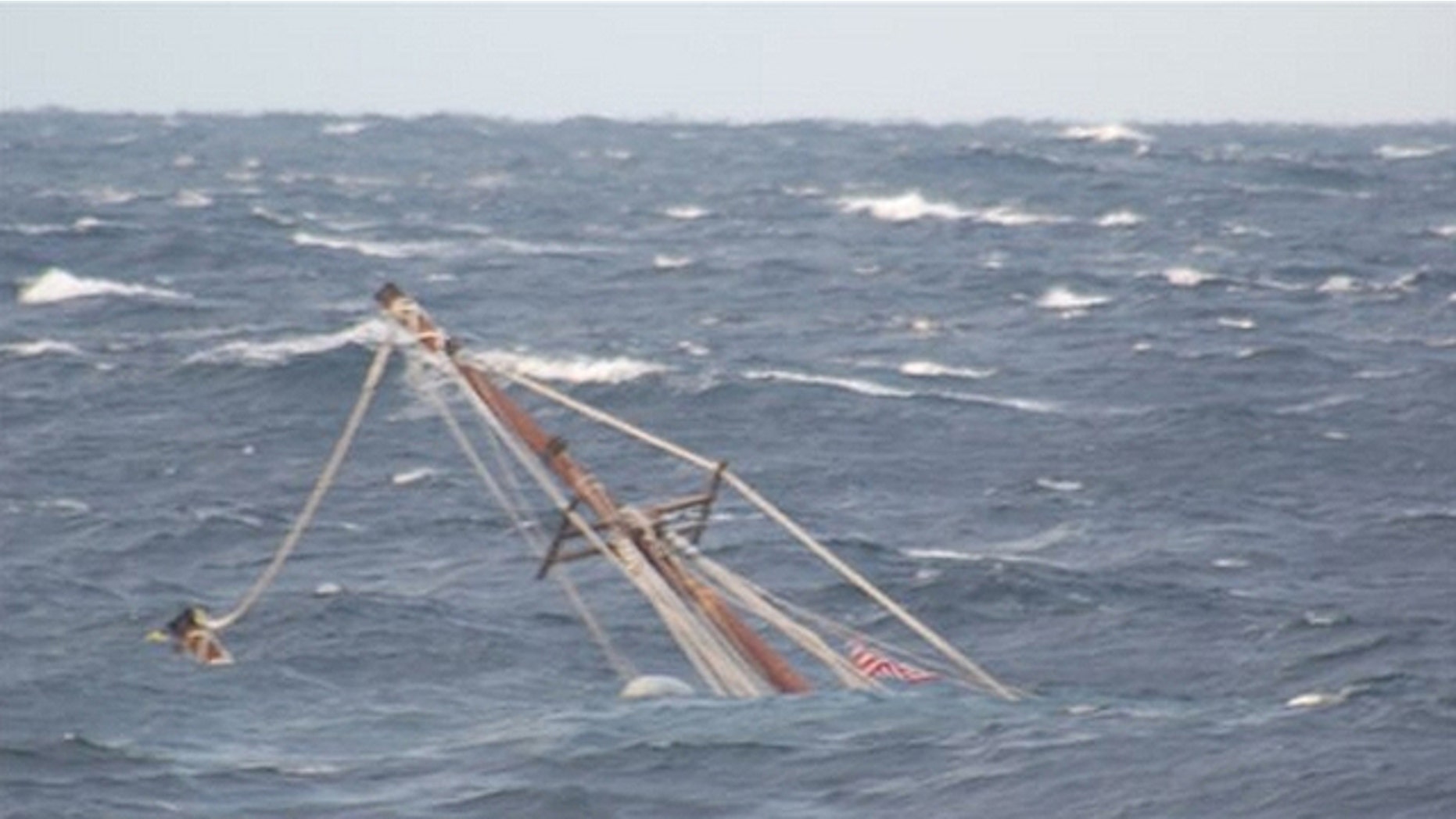 In this photo released by the U.S. Coast Guard, a mast of the 88-foot sailing vessel Raw Faith protrudes from the water as the boat sinks in approximately 6,000 feet of water about 166 miles southeast of Cape Cod, Mass., on Wednesday. The crew of the Kittery, Maine, Coast Guard Cutter Reliance remained on scene until the vessel sank. (U.S. Coast Guard)