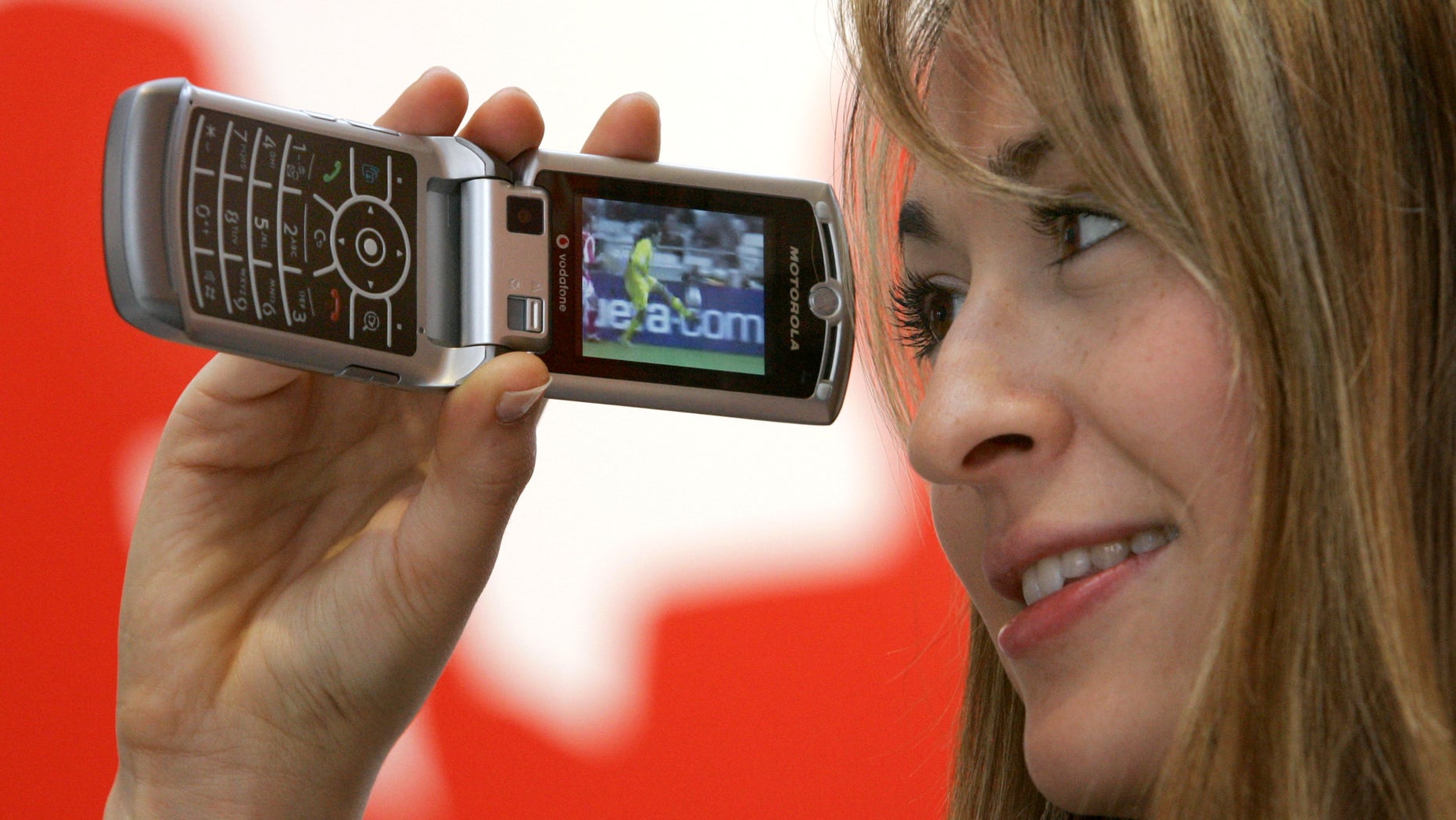 File photo - A model presents a TV service on a Motorola RAZR V3x phone with UMTS feature by Vodafone at the CeBIT computer fair in the northern German town of Hanover March 7, 2006. (REUTERS/Fabrizio Bensch)