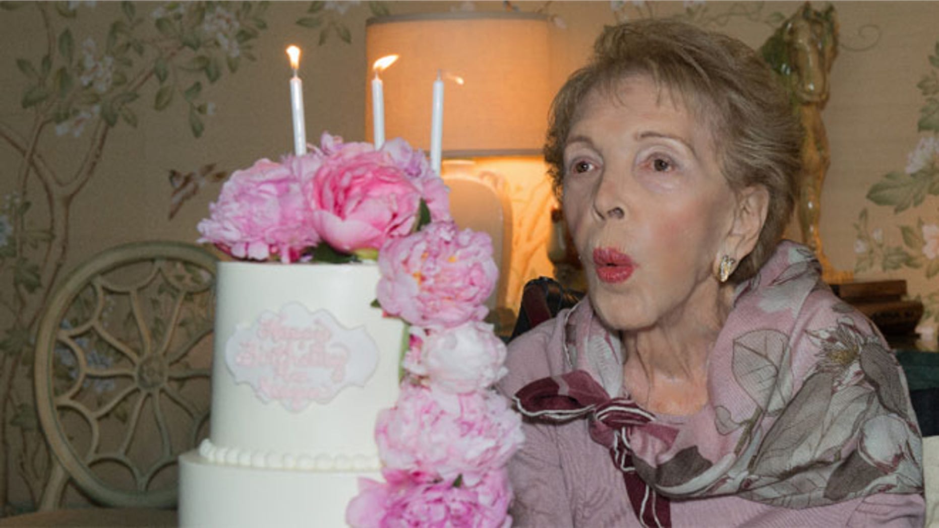 Nancy Reagan blows out her birthday candles on her 94th birthday on July 6, 2015.<br>
