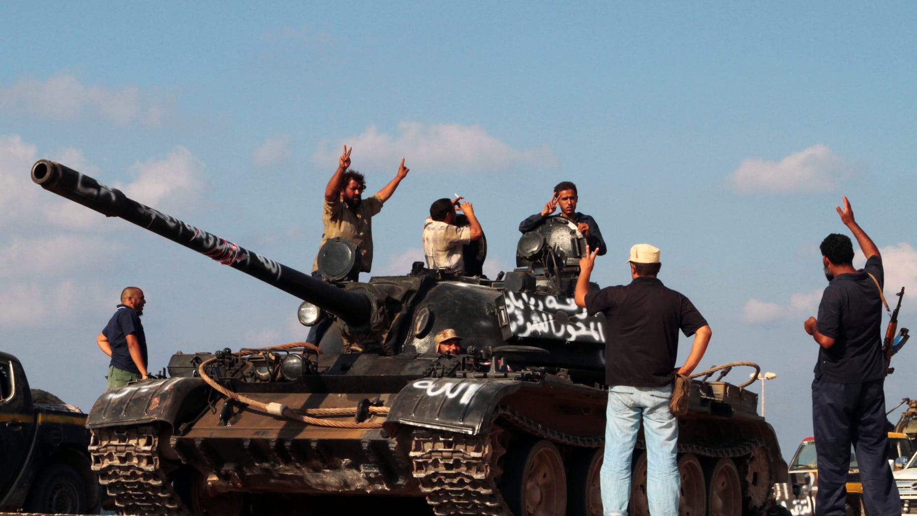 Sept. 17: Revolutionary fighters ride a tank as they celebrate on their way back from the front line in Sirte, Libya.