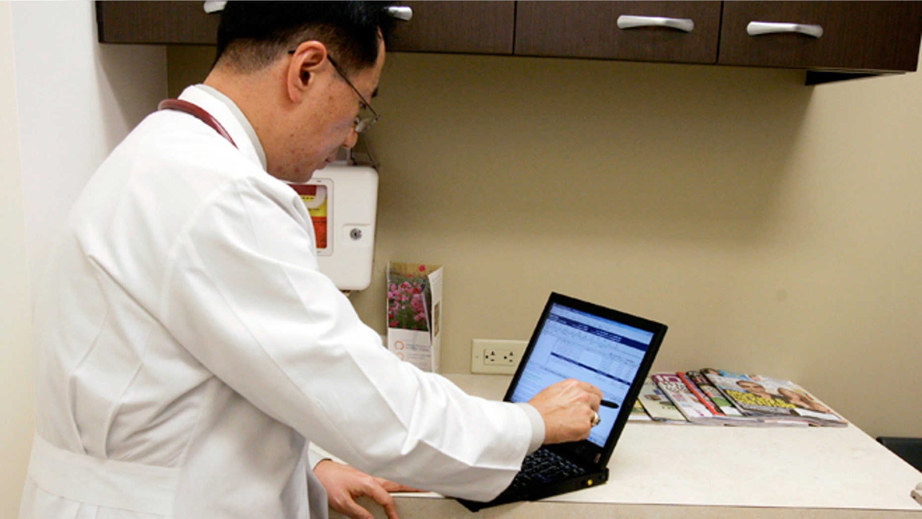 Aug. 25, 2009: Allergy specialist Dr. Theodore Kim uses an electronic medical record (EMR) system on a tablet notebook to manage medical records of patients at his practice in Chantilly, Virginia.