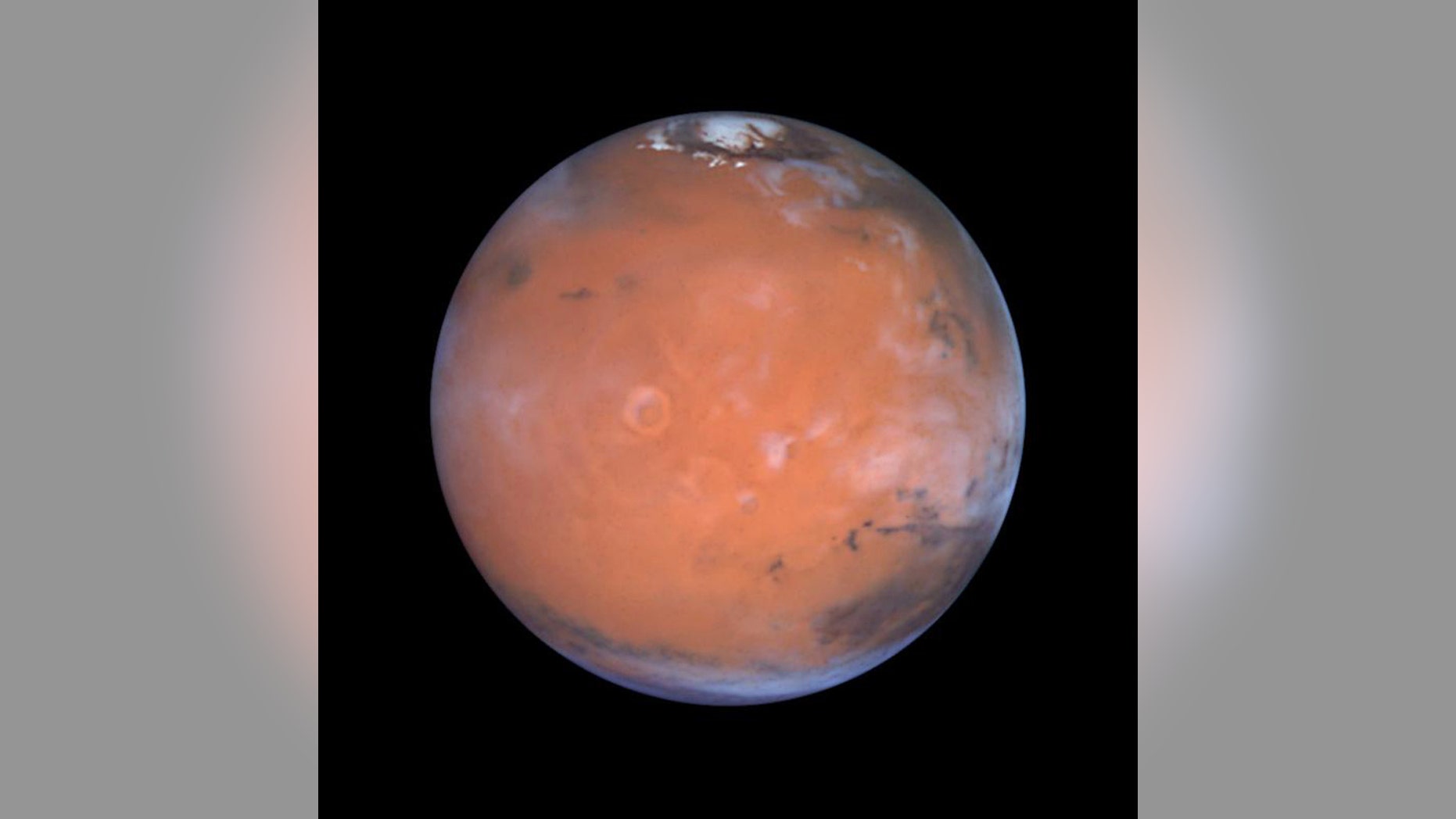 New research into old data suggests that ice may hide around Mars' equator. Here, the Red Planet is seen in a vivid Hubble view.