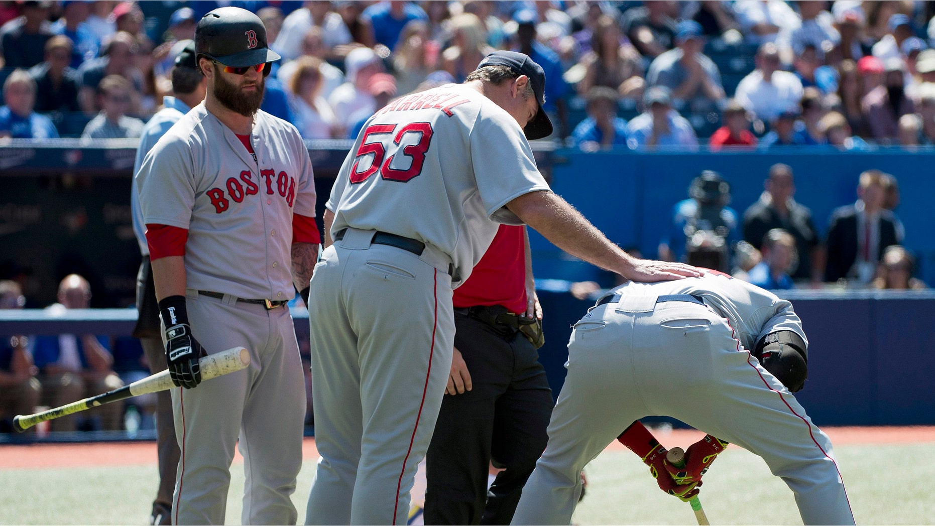 Boston Red Sox manager John Farrell (53) talks with David Ortiz, right, after Ortiz injured himself against the Toronto Blue Jays during ninth-inning baseball game action in Toronto, Thursday, July 24, 2014. (AP Photo/The Canadian Press, Nathan Denette)