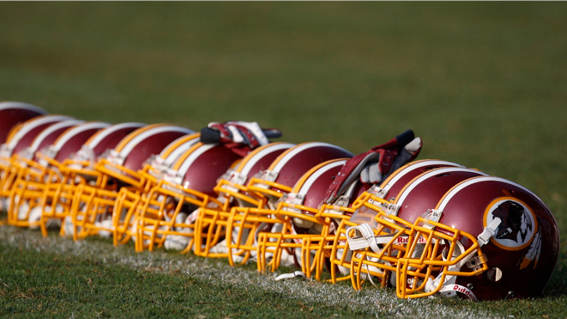 Aug. 4, 2009: Washington Redskins helmets are displayed on the field during NFL football training camp at Redskins Park in Ashburn, Va. (AP/Pablo Martinez Monsivais, File)
