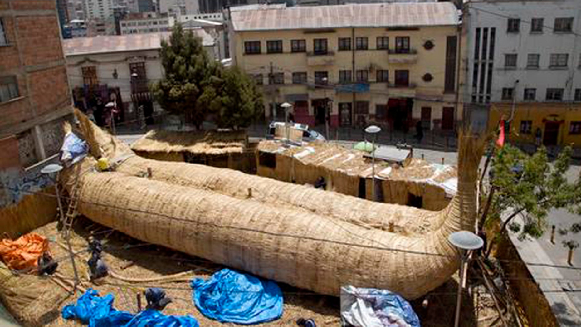 Workers continue construction of a reed boat named the "Viracocha III," and built by Bolivian Aymara Indians, in La Paz, Bolivia, Wednesday, Oct. 19, 2016. American explorer Phil Buck is preparing to cross the Pacific Ocean from South America to Australia in the Viracocha III, a three-masted boat that was made from several tons of dried reeds of the totora plant. The expedition seeks to prove that ancient mariners could have made such journeys across huge ocean expanses in reed ships, and that such vessels could have been a factor in human migration. (AP Photo/Juan Karita)