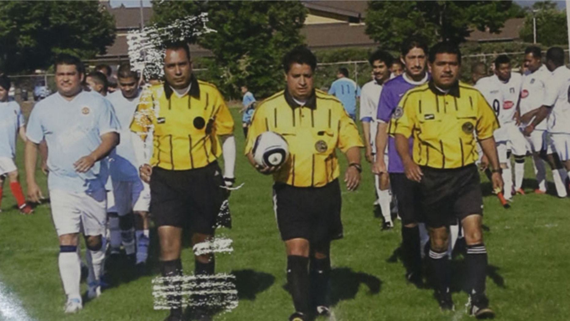 This image shows an undated photo of Riccardo Portillo, center.