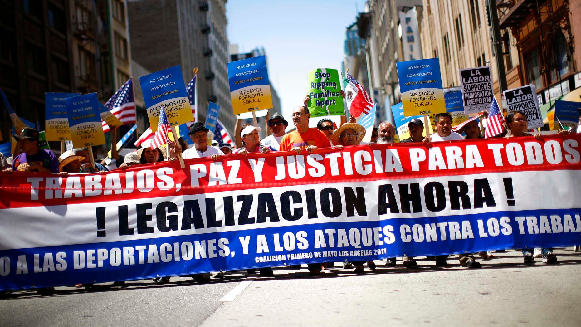 LOS ANGELES, CA - MAY 1: Demonstrators march during a May Day protest May 1, 2011 in Los Angeles, California. Thousands of people marched for immigration reform, among other issues. (Photo by Eric Thayer/Getty Images)