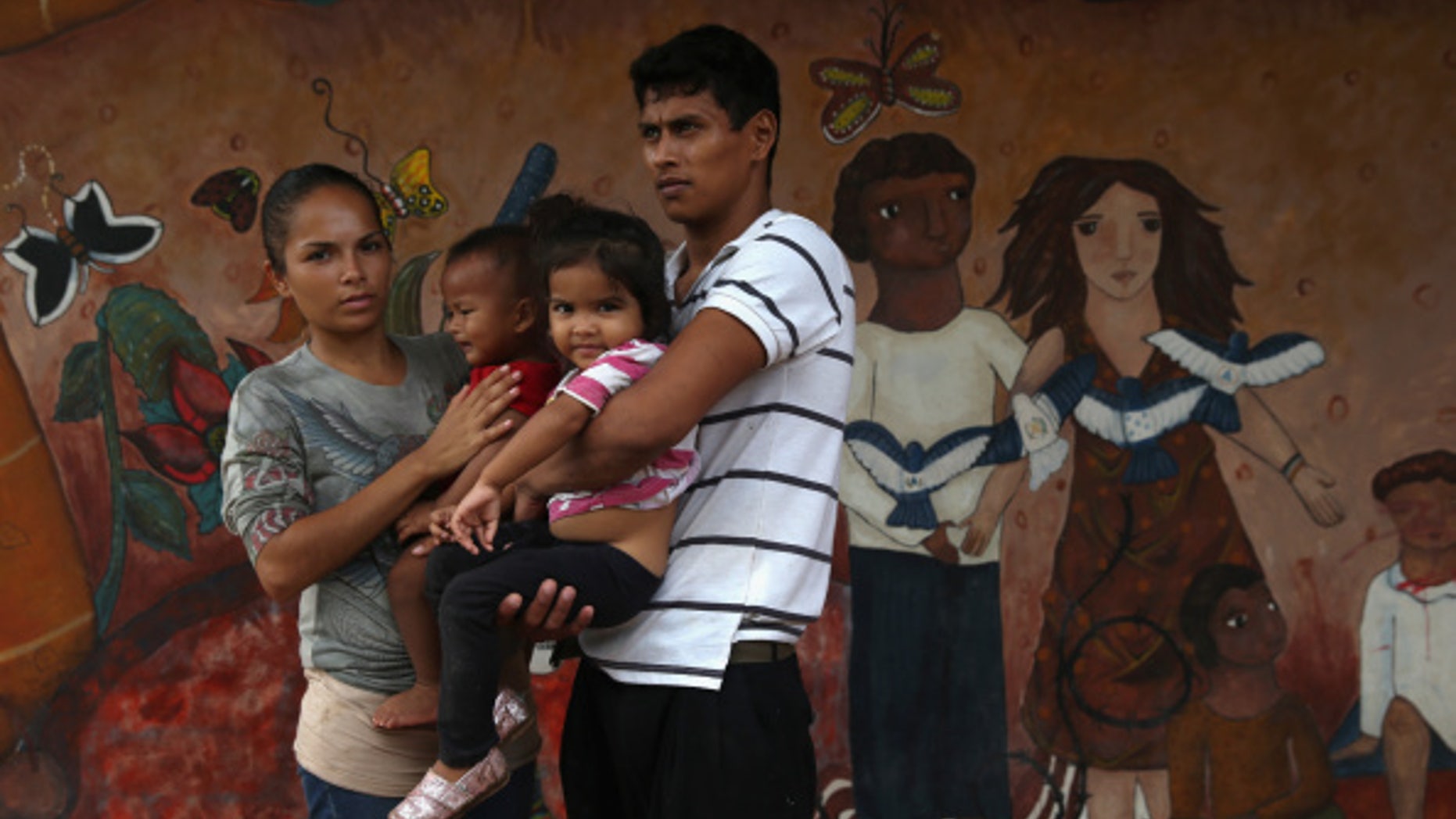 TENOSIQUE, MEXICO - SEPTEMBER 15: A family of immigrants arrives from Honduras to a shelter for undocumented immigrants on September 15, 2014 in Tenosique, Mexico. The family, including U.S. citizen Gloria Francesca Bucato, 22, her partner, Honduran citizen Louis Felipe and their two children Baylee Bucato, 3, and Luis Bucato, 1, both born in Honduras plans to present themselves to U.S. Border Patrol agents once they manage to cross into the United States. The shelter, called La 72, is run by Fransiscan friars and is the first stop for thousands of Central American immigrants crossing north through Mexico to reach the United States. Many risk riding atop "La Bestia" or The Beast, a freight train which passes through Tenosique, in Mexico's southern state of Tabasco. The number of immigrants making the perilous trek has diminished from a springtime high, due to Mexican and U.S. law enforcement operations to stem the flow. (Photo by John Moore/Getty Images)