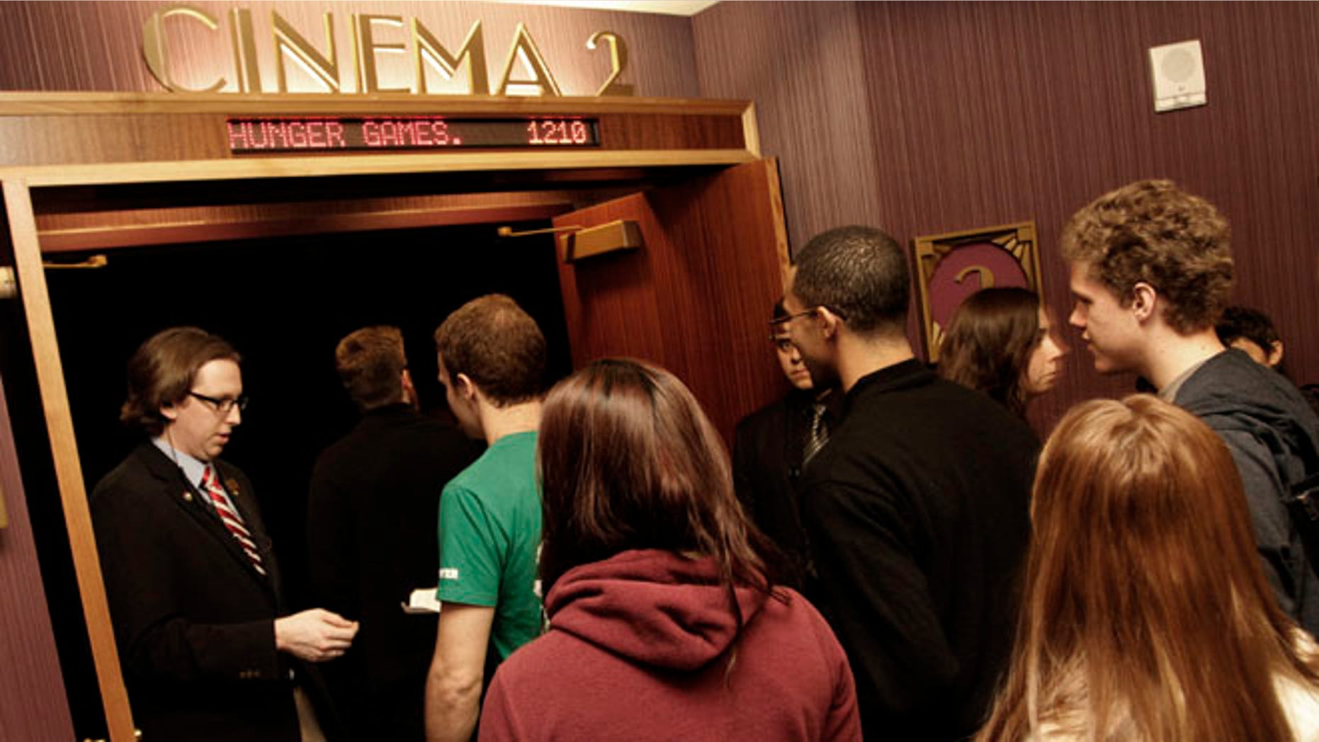 Workers for Regal Entertainment Group, like the one seen here collecting tickets from movie-goers, have had their work weeks shortened in a new company-wide mandate. Internal documents obtained by FoxNews.com show that the cuts were enacted in response to the Affordable Care Act.