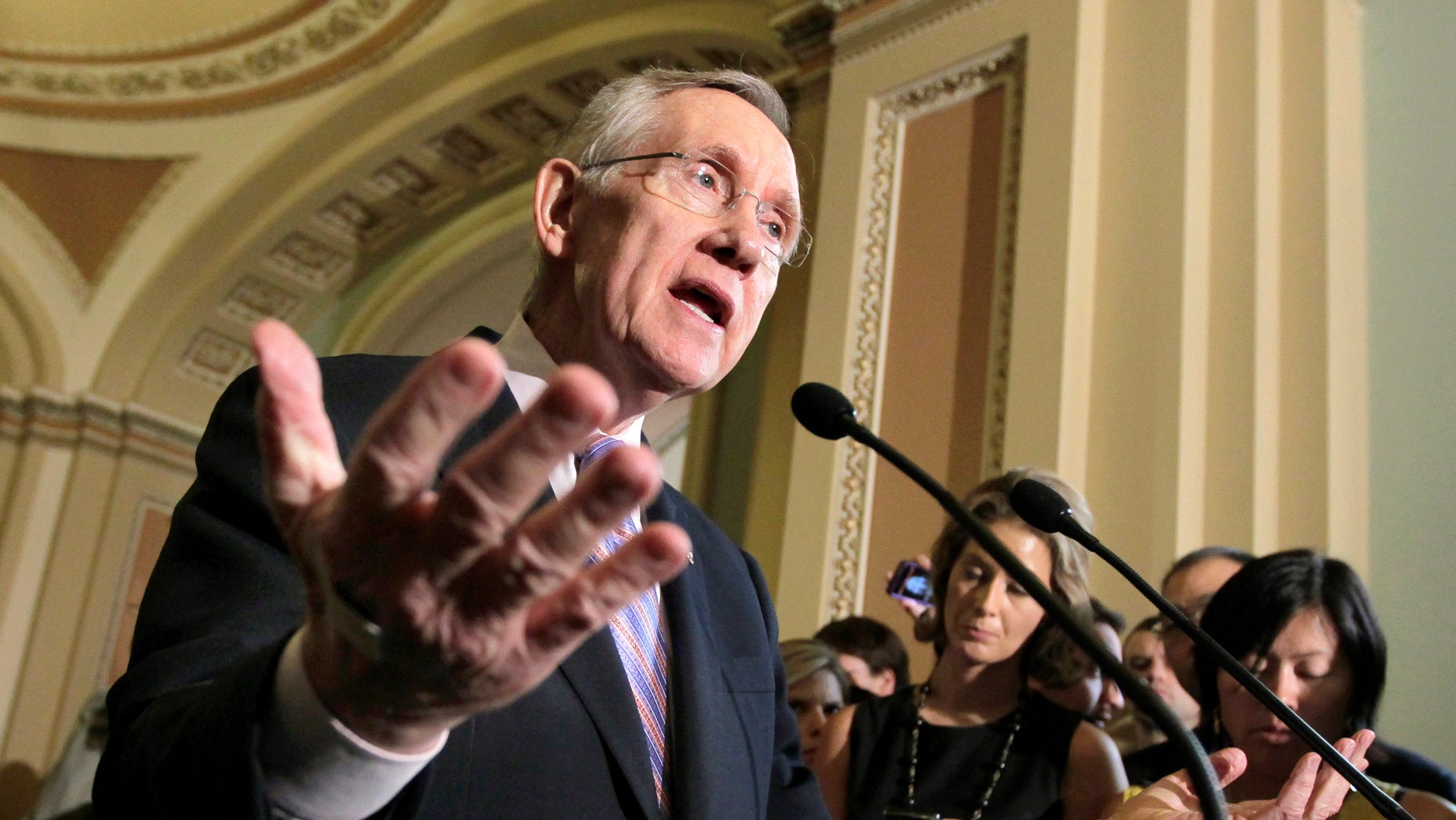 Senate Majority Leader Harry Reid of Nev. speaks with reporters about the conflicting plans to deal with the debt crisis, Tuesday, July 26, 2011, on the Hill Capitol in Washington.