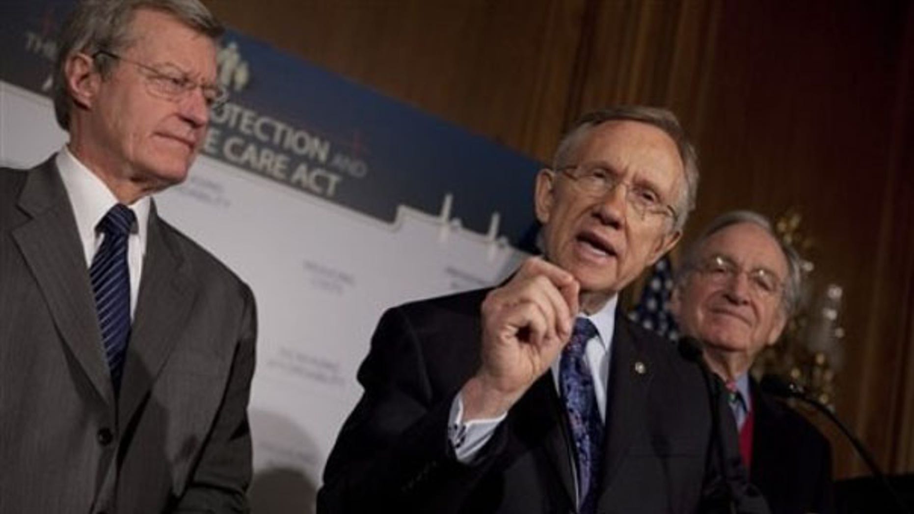 Senate Majority Leader Harry Reid, center, along with Sen. Max Baucus, left, and Sen. Tom Harkin, gestures during a health care news conference on Capitol Hill Dec. 21. (AP Photo)