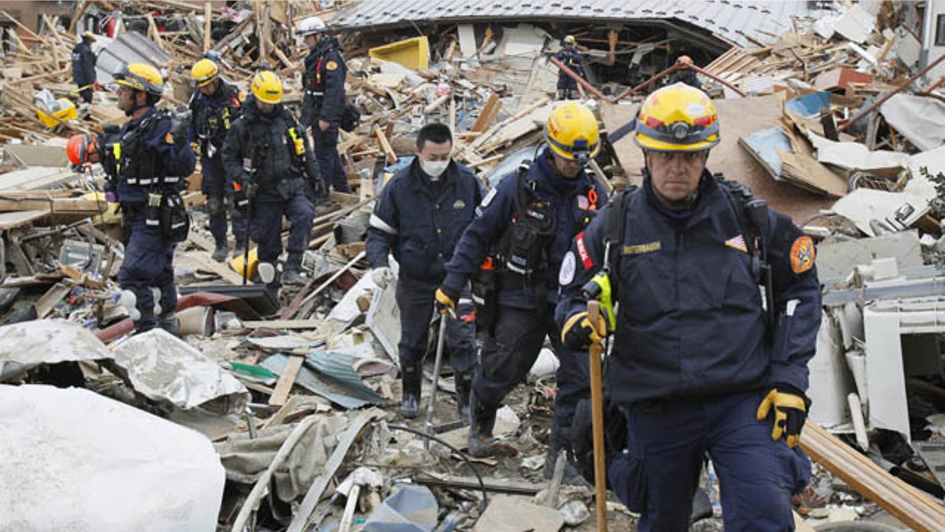 March 15: Members of a U.S. rescue team work in the rubble at the earthquake and tsunami devastated area in Ofunato, Iwate Prefecture, Japan, on Tuesday, four days after the devastation. (AP/Kyodo News)