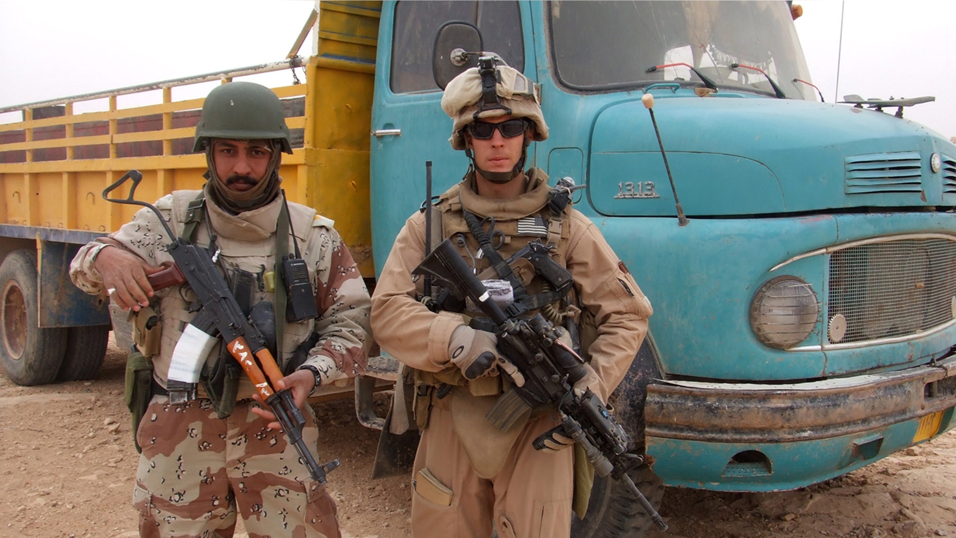 This 2007 photo provided by Chase Millsap shows Millsap with the Captain standing next to a suspected truck bomb following a successful raid in Al Anbar, Iraq.