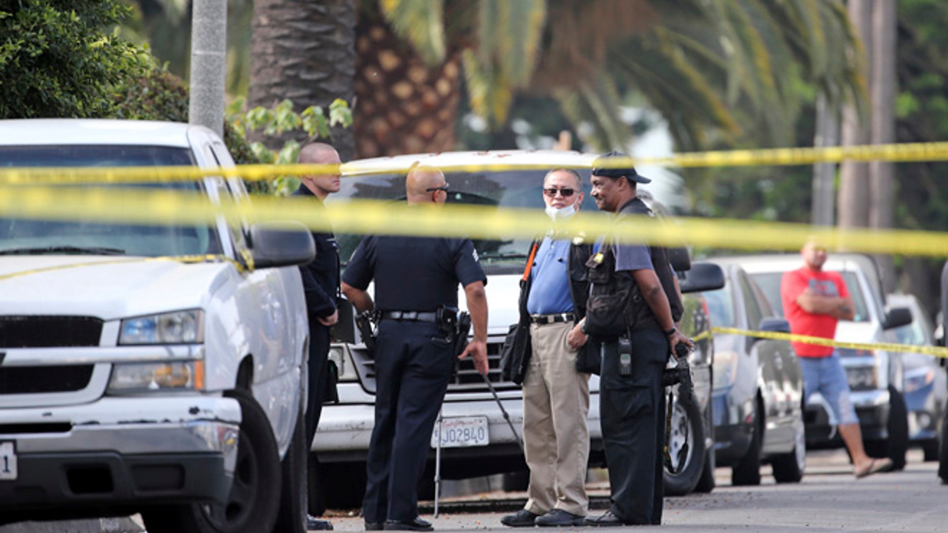 Los Angeles police investigators work the scene of a fatal shooting in the Crenshaw District neighborhood of Los Angeles, Saturday, Oct. 15, 2016.