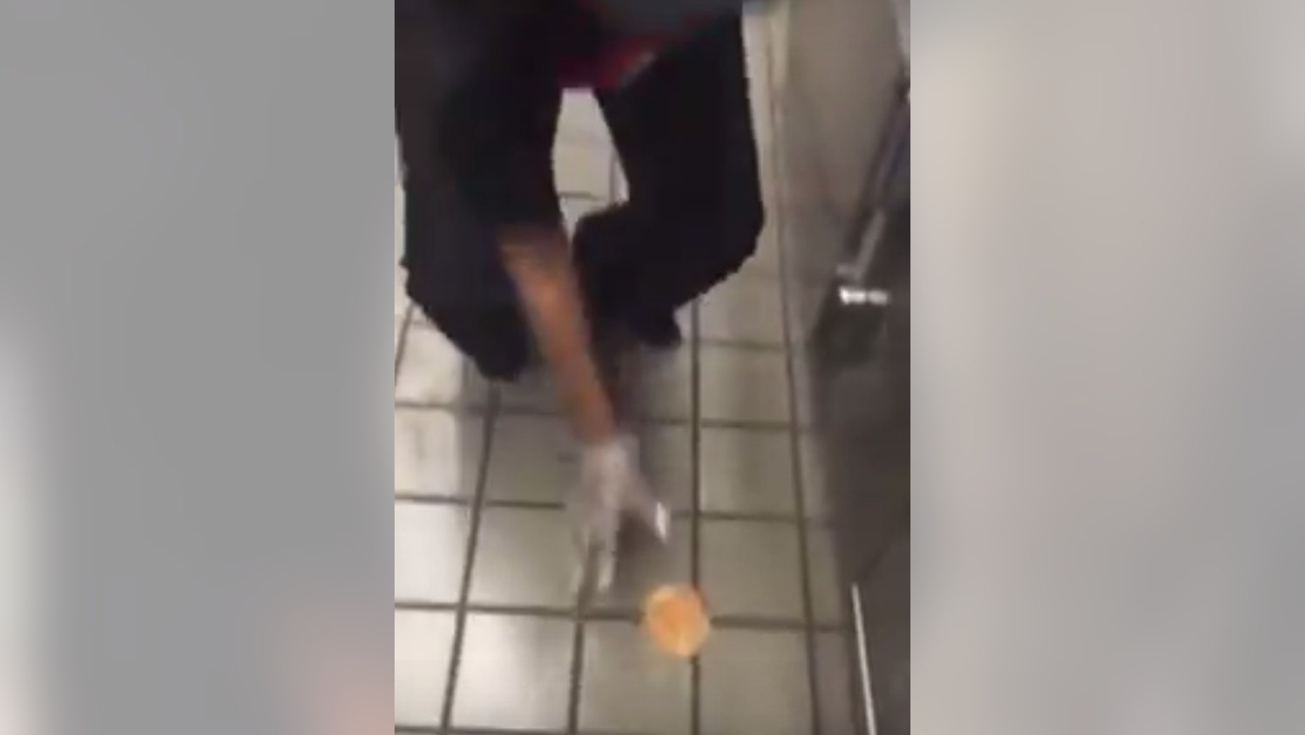 A Checkers employee has been fired for wiping a burger bun on the kitchen floor.