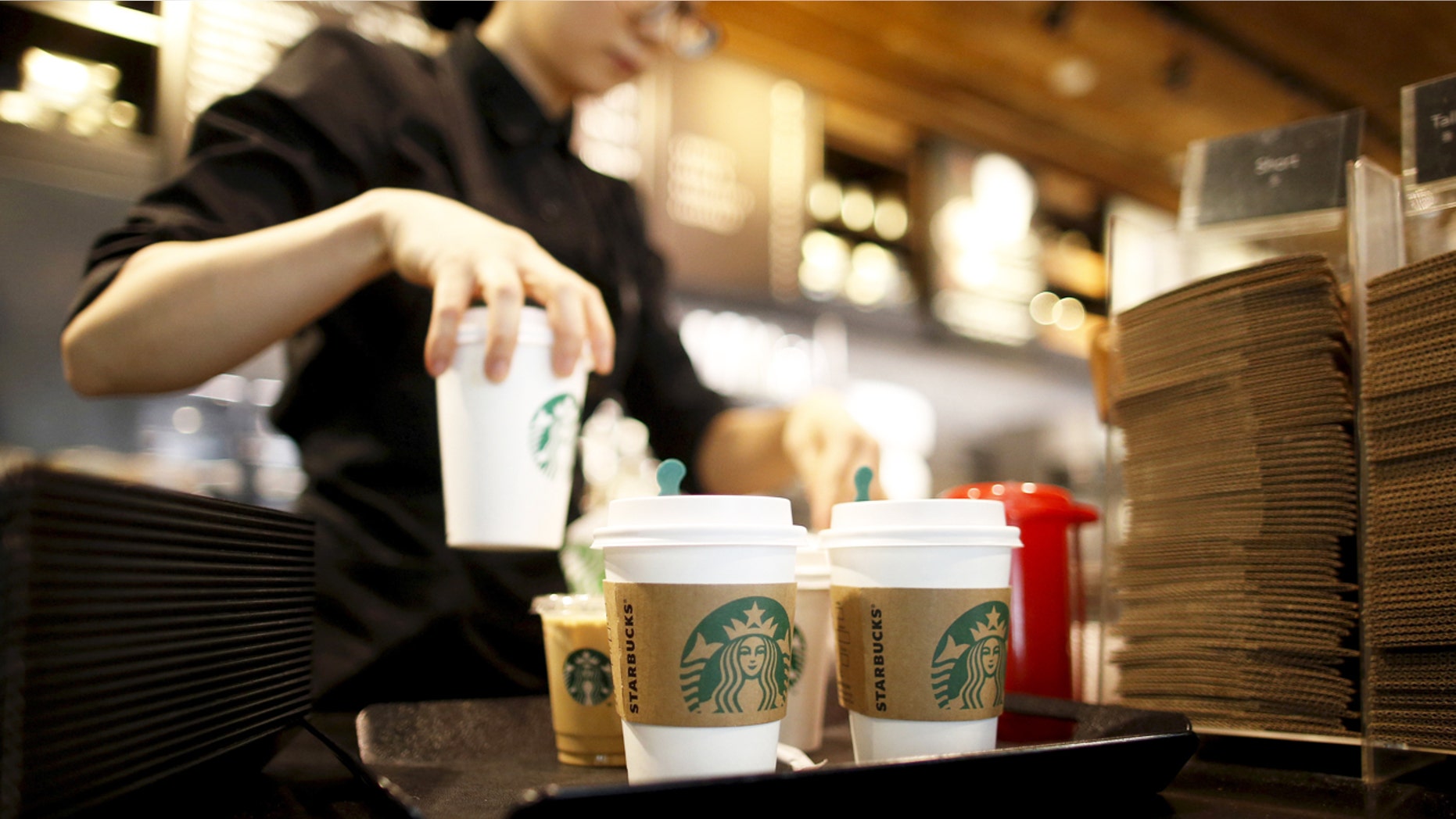A staff serves beverages at a Starbucks coffee shop in Seoul, South Korea, in this March 7, 2016, file photo. REUTERS/Kim Hong-Ji/Files GLOBAL BUSINESS WEEK AHEAD PACKAGE - SEARCH 'BUSINESS WEEK AHEAD APRIL 18' FOR ALL IMAGES - RTX2AE8U