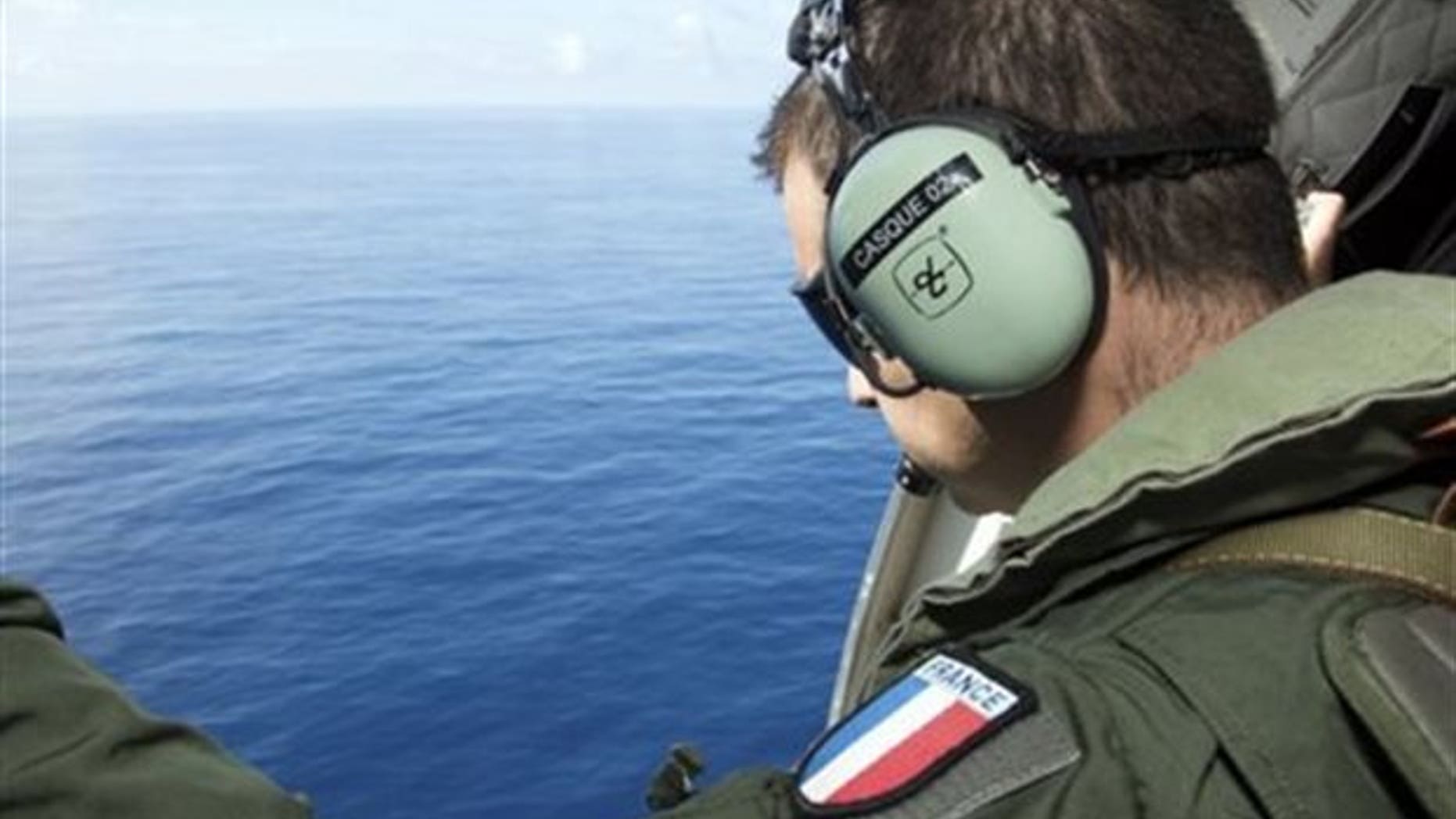 A search team member looking for MH370 wreckage off Reunion Island in August.