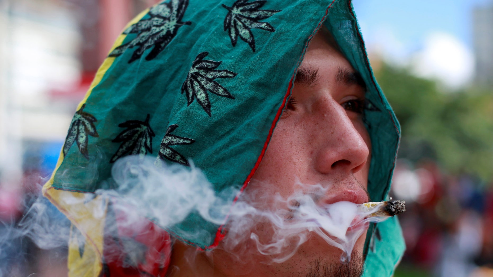 A man smokes marijuana during a global March for marijuana in Bogota, Colombia, May 7, 2016.