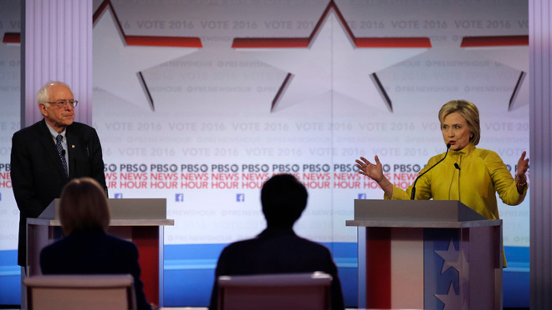 Democratic U.S. presidential candidate former Secretary of State Hillary Clinton speaks as Senator Bernie Sanders listens at the PBS NewsHour Democratic presidential candidates debate in Milwaukee, Wisconsin, February 11, 2016. REUTERS/Jim Young - RTX26KQQ