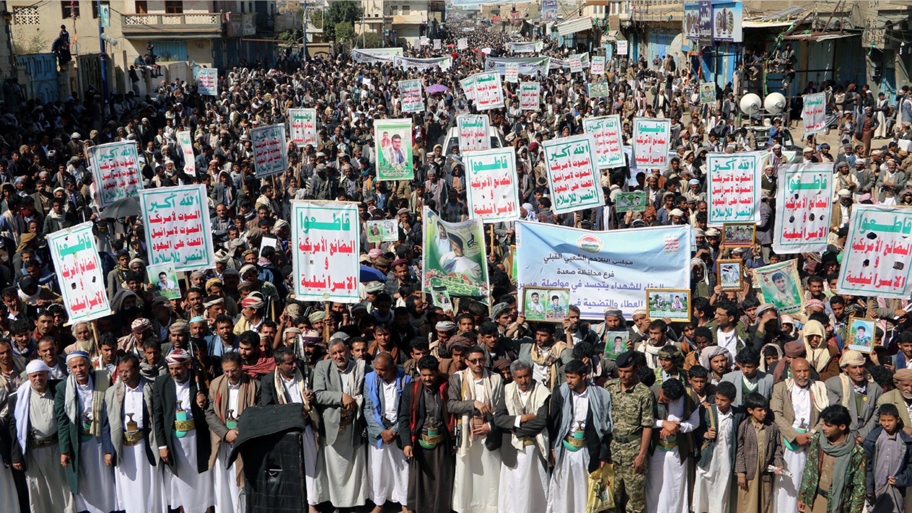 Followers of the Houthi movement rally to mark the 'Martyr Day' in Saada, Yemen February 5, 2018. The placards read: "Allah is the greatest. Death to America, death to Israel, a curse on the Jews, victory to Islam." REUTERS/Naif Rahma - RC19C29CE220
