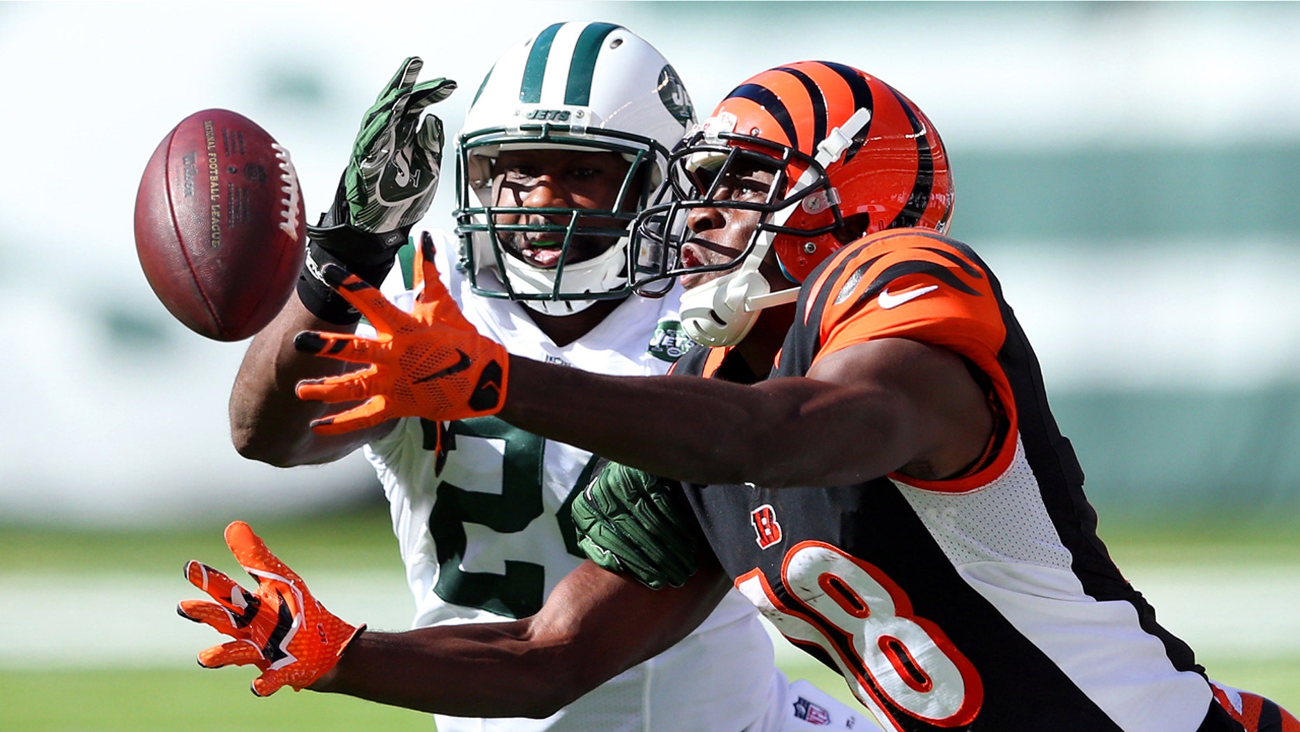 Sep 11, 2016; East Rutherford, NJ, USA; Cincinnati Bengals wide receiver A.J. Green (18) catches a pass in front of New York Jets corner back Darrelle Revis (24) during the fourth quarter at MetLife Stadium. Mandatory Credit: Brad Penner-USA TODAY Sports - RTSN9QC