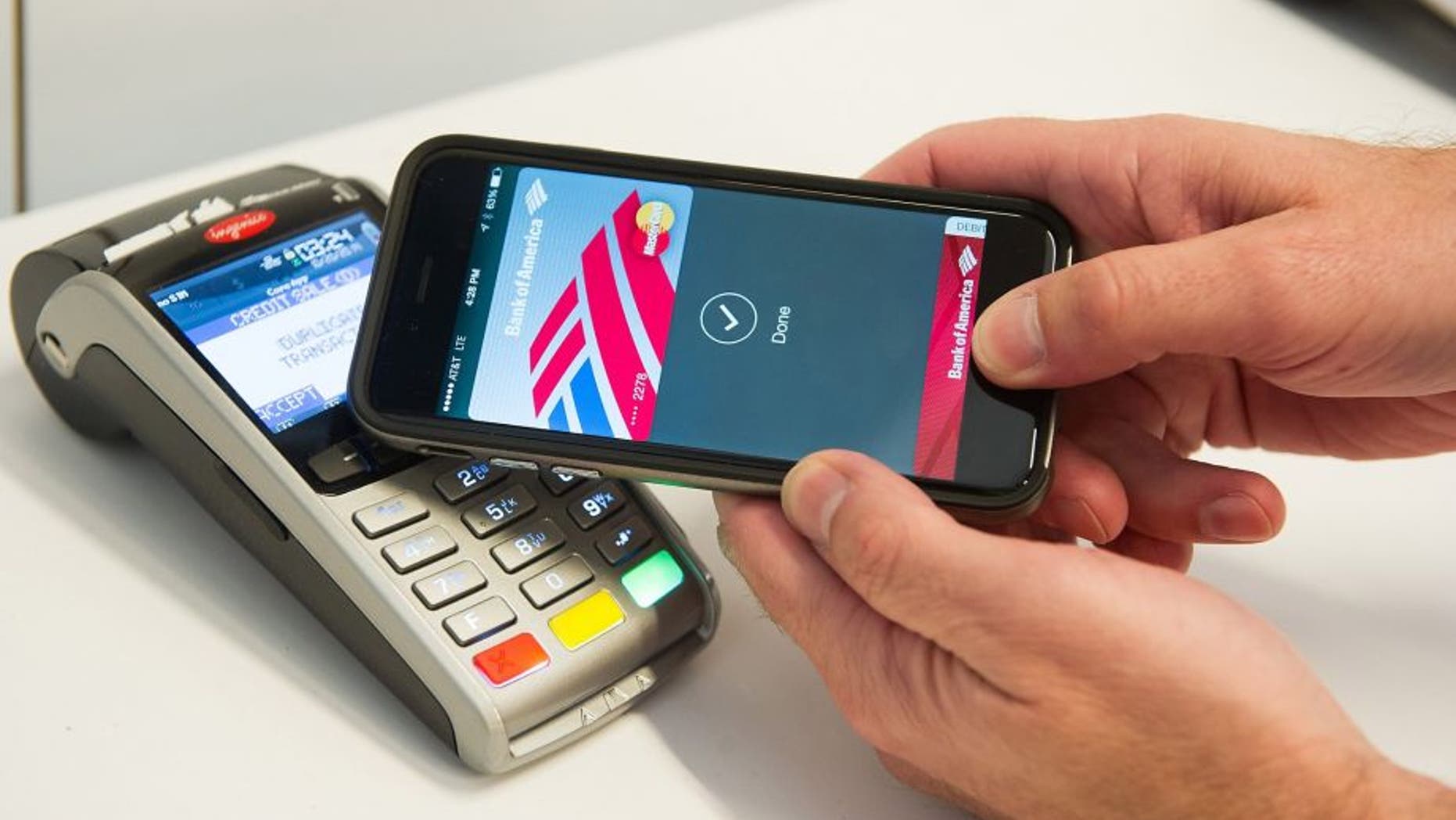 An Apple Pay user demonstrates how to pay via cell phone.