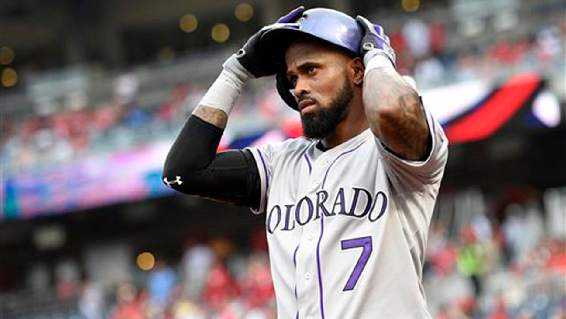 In this Aug. 7, 2015, file photo, Colorado Rockies shortstop Jose Reye adjusts his batting helmet before a baseball game against the Washington Nationals in Washington.