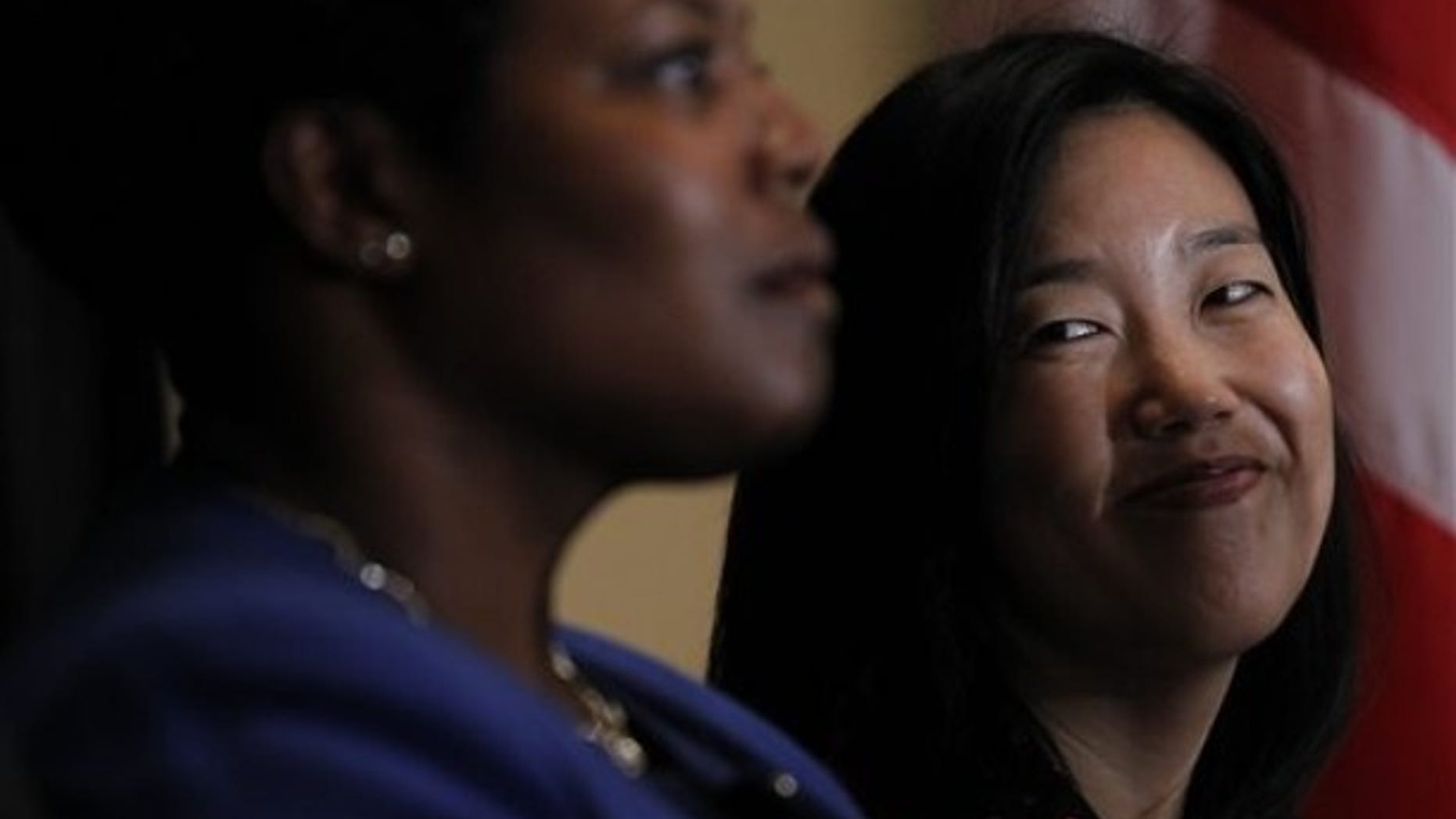 DC Schools Chancellor Michelle Rhee, right, smiles during an announcement that she is resigning, Wednesday, Oct. 13, 2010, during a news conference in Washington. (AP)