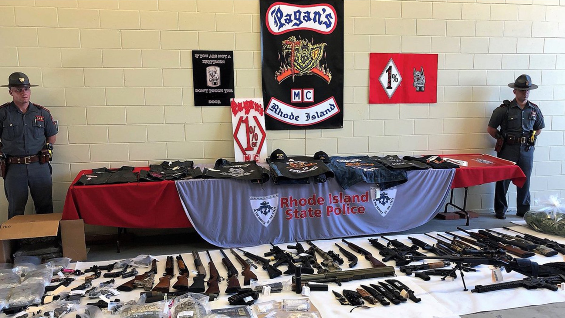 Authorities on Wednesday arrested 50 members of two rival biker gangs in Rhode Island, seizing 53 illegal guns and large quantities of narcotics.