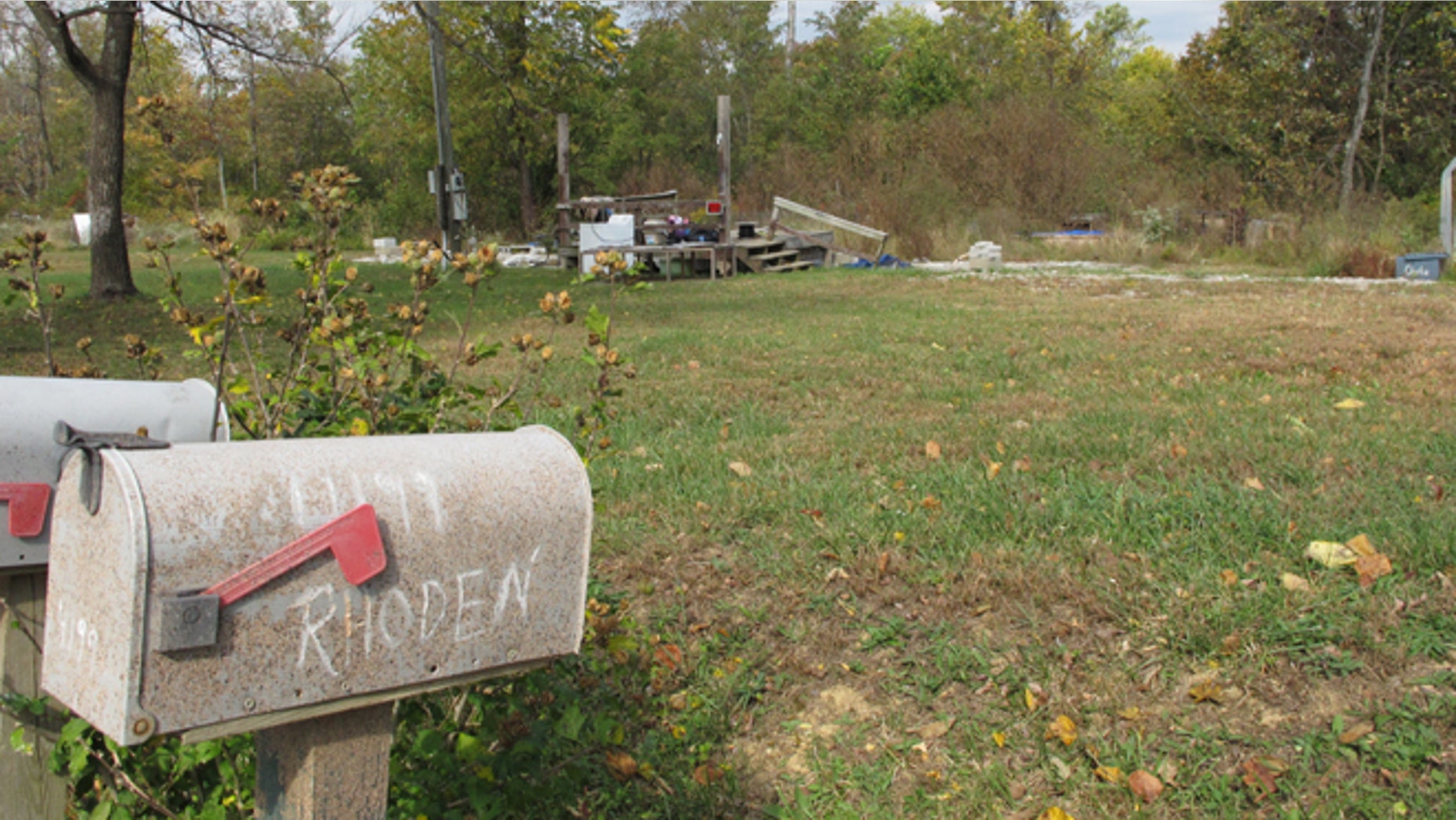 In this Tuesday, Oct. 18, 2016 photo, a porch is all that remains of the home on Union Hill Road after investigators removed the trailer where the bodies of Clarence "Frankie" Rhoden and Hannah Gilley were found on April 22, two of eight family members found shot to death that day in a still-unsolved crime, in Piketon, Ohio. (AP Photo/Andrew Welsh-Huggins)