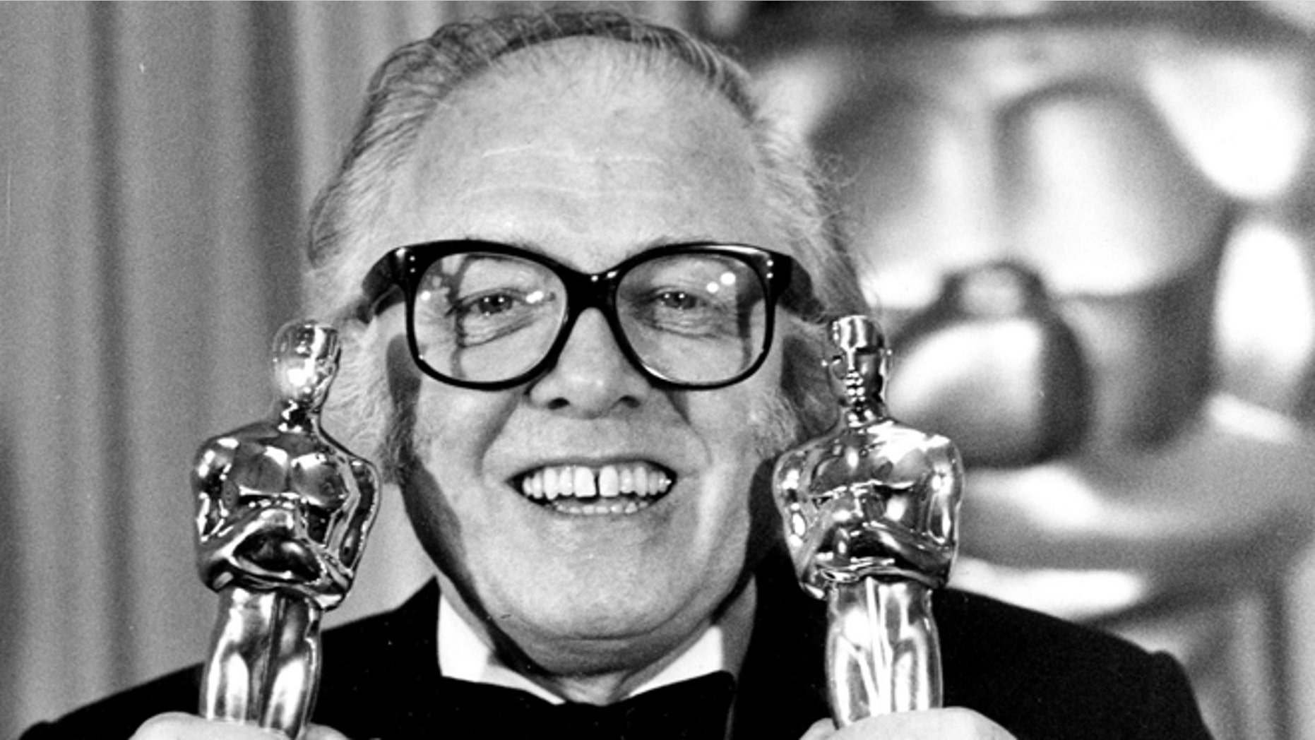 In this Monday, April 11, 1983 file photo, British actor and director Richard Attenborough holds his two Oscars for his epic movie "Gandhi" at the 55th annual Academy Awards in Los Angeles, Ca. Acclaimed actor and Oscar-winning director Richard Attenborough, whose film career on both sides of the camera spanned 60 years, died on Sunday, Aug. 24, 2014. He was 90.
