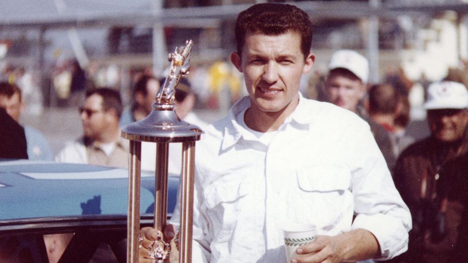 DAYTONA BEACH, FL â February 23, 1964: Richard Petty holds his trophy in victory lane at Daytona International Speedway after winning the Daytona 500 NASCAR Cup race. Petty and his new hemi-engined Plymouth dominated the event leading 184 of the 200 laps. (Photo by ISC Images & Archives via Getty Images)