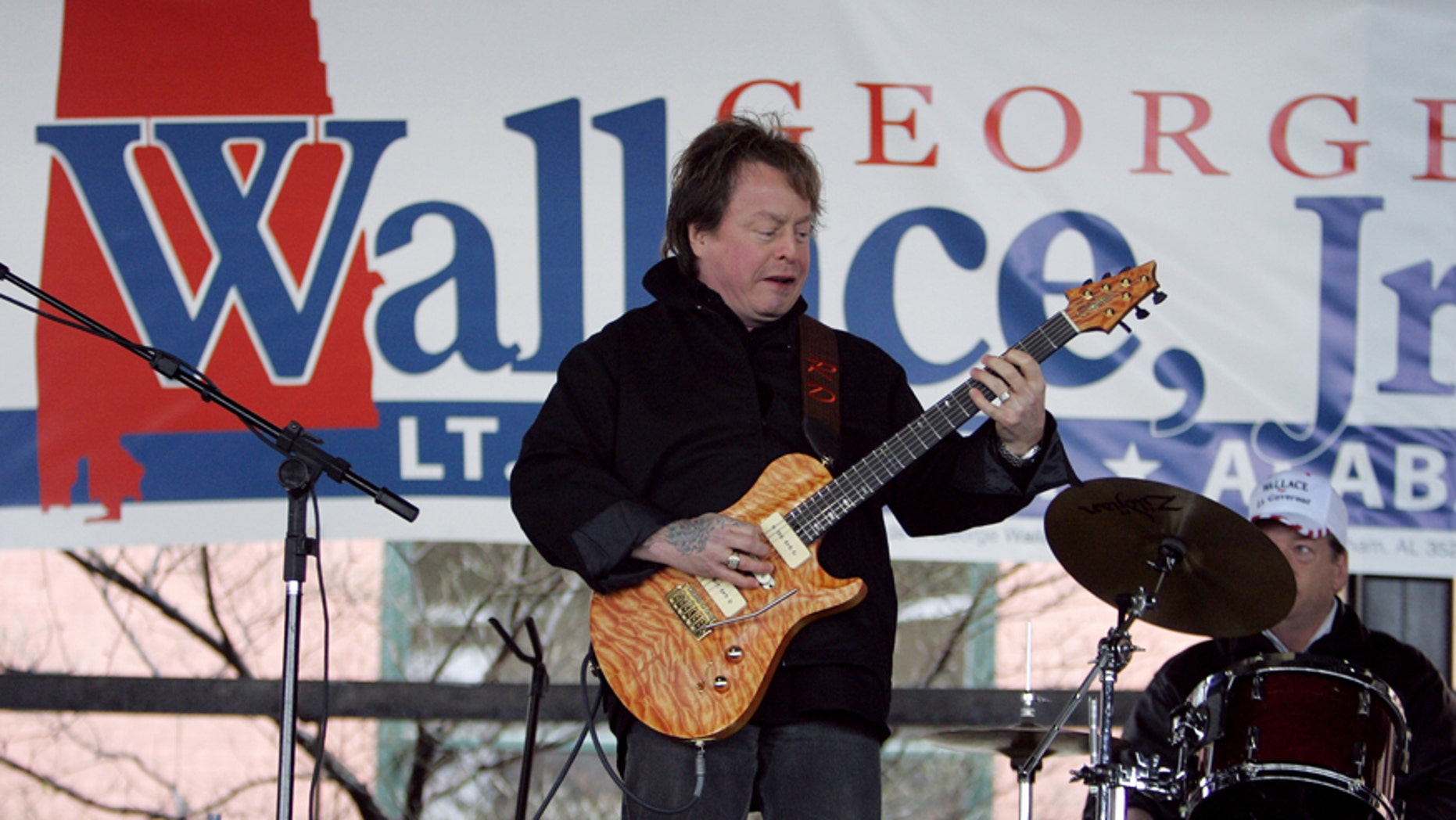 In this Feb. 18, 2006 file photo, Rick Derringer performs during a campaign rally kicking off George Wallace Jr's bid for the office of lieutenant governor in Montgomery, Ala. Prosecutors say Derringer carried a loaded gun in his carry-on bag on a Delta Air Lines flight from Cancun, Mexico, but was stopped after landing in Atlanta.